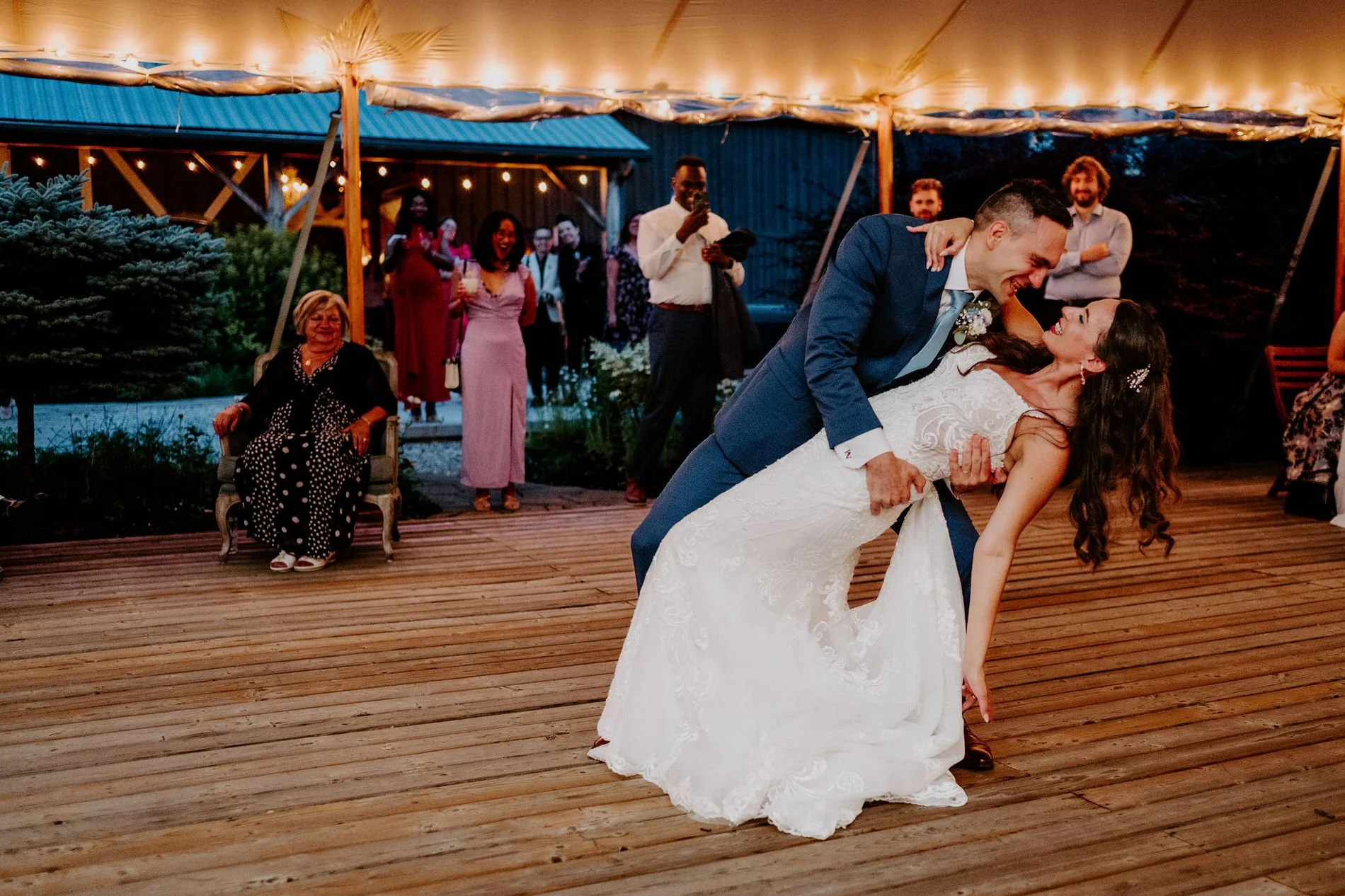 Petar dipping Holly during their first dance under the string-lit tent at Evermore in Ottawa