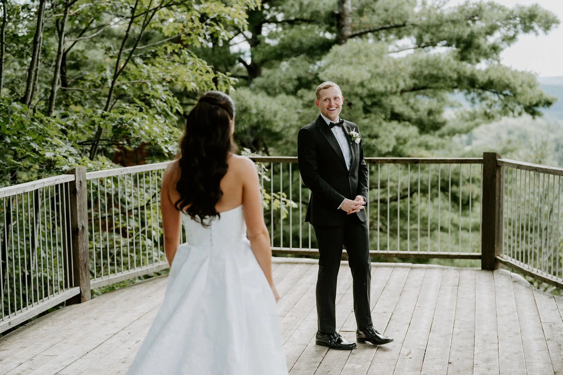Will grinning as he turns to see Kylie for their first look on the lookout deck at Le Belvedere