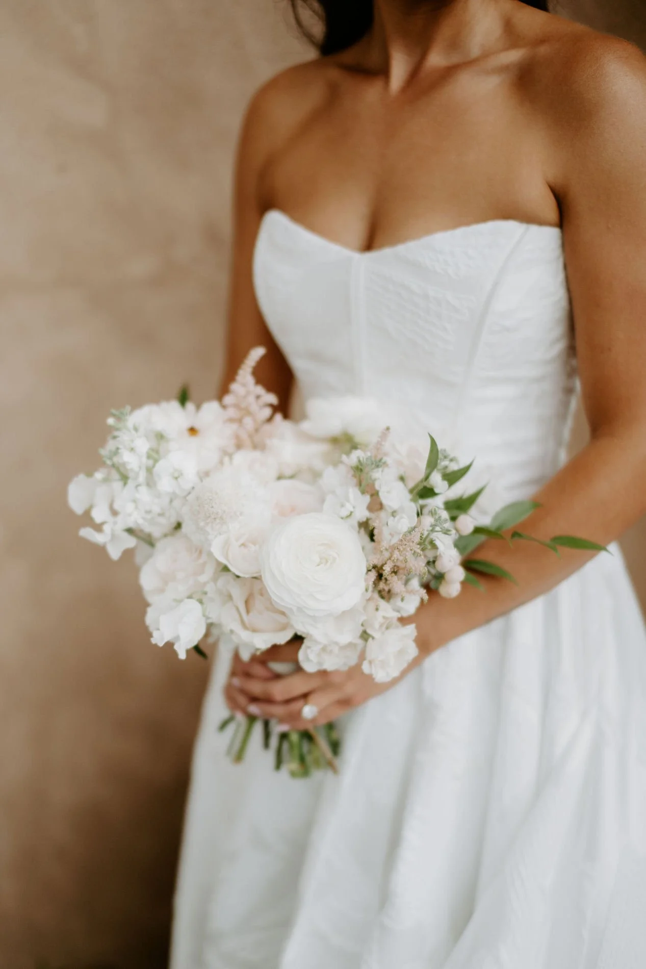 Close-up of Kylie's white and blush bouquet of ranunculus, garden roses and astilbe