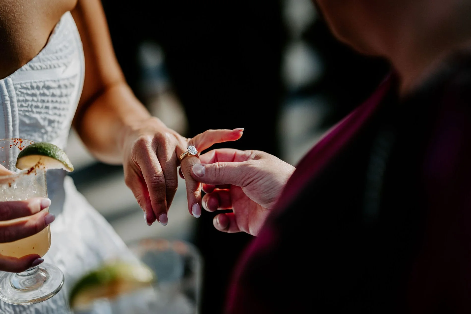 A guest admiring Kylie's engagement ring during cocktail hour