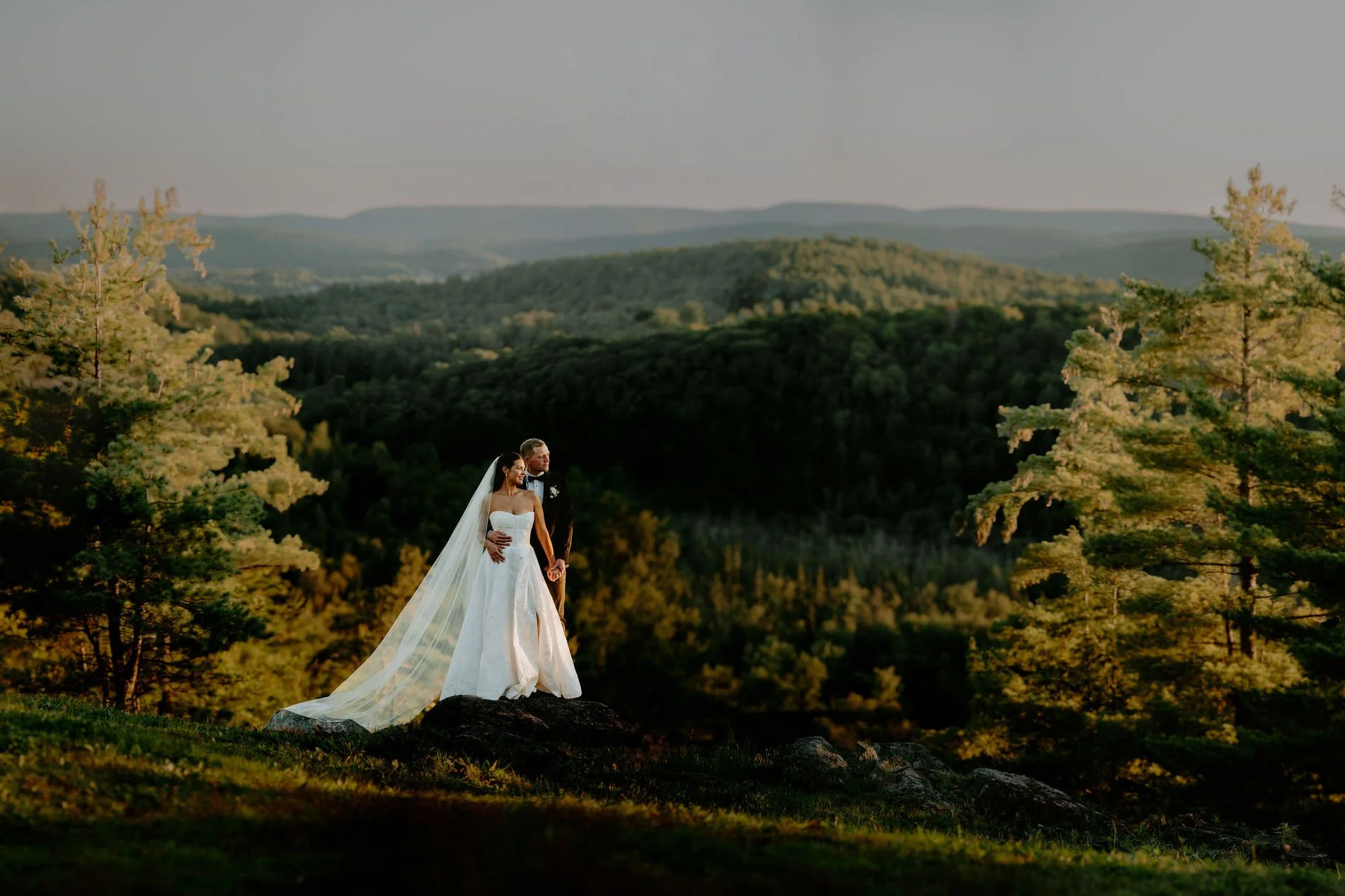 a bride and groom at le belvedere at sunset