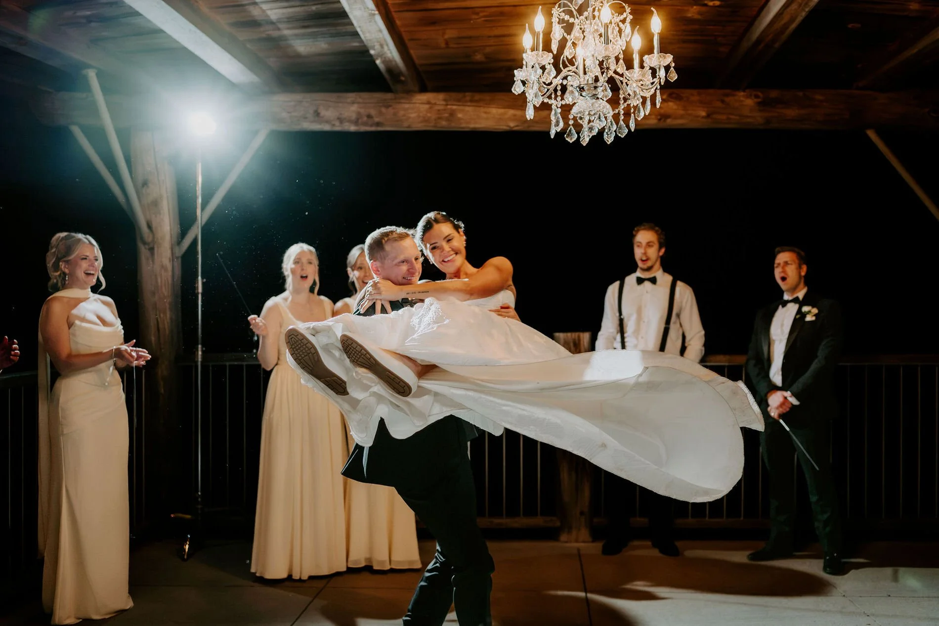 Will lifting and spinning Kylie under the chandelier as the wedding party cheers