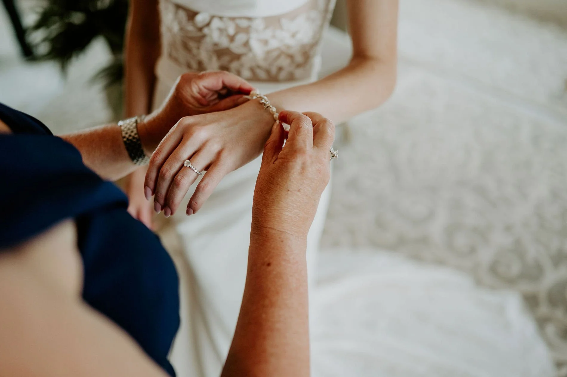 Close-up of a woman fastening a sparkling bracelet on Emily's wrist
