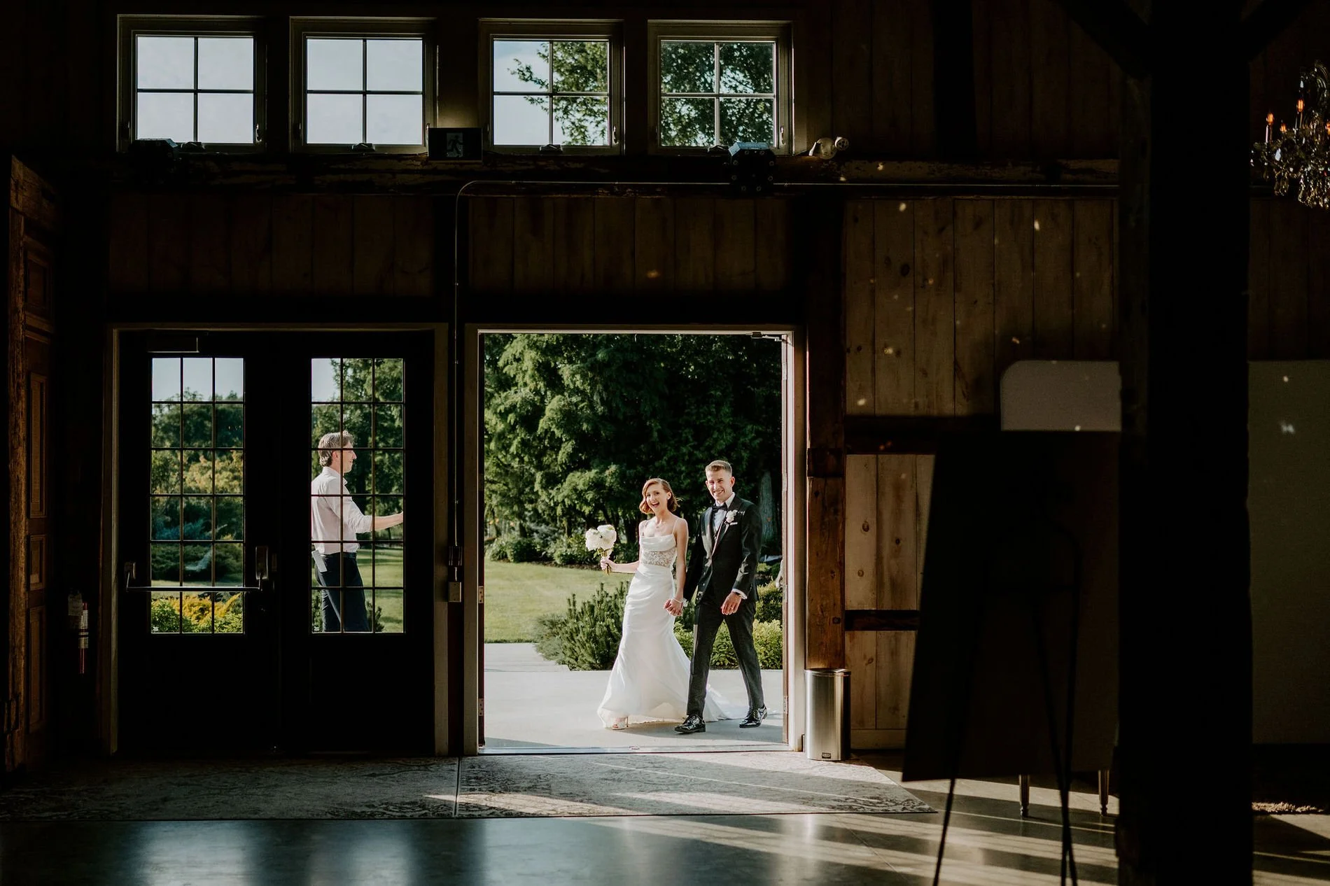 Emily and Austin arriving at the open doors of the Stonefields barn for their reception