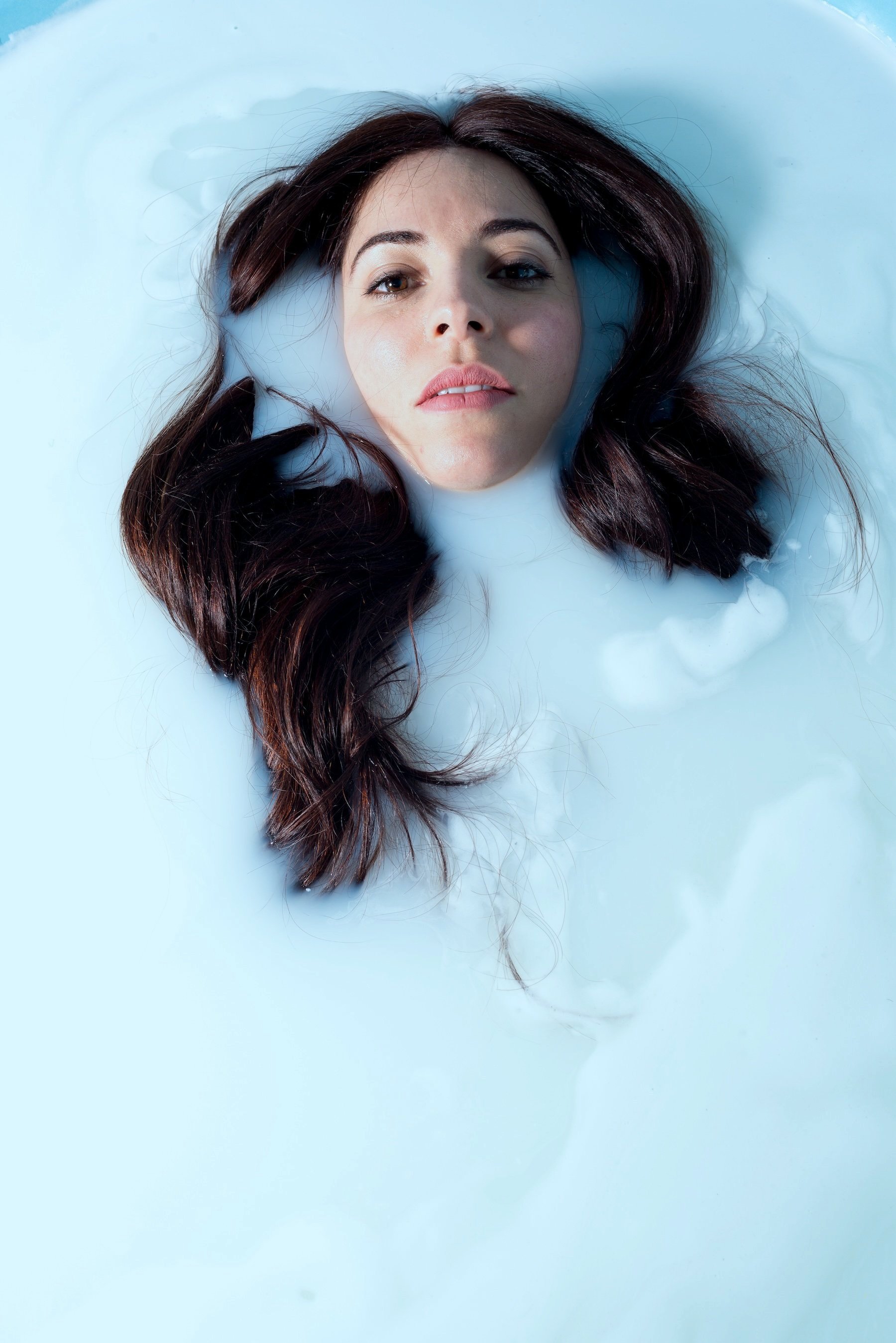 Maje Casben headshot in white milk bath – cinematic and emotional expression