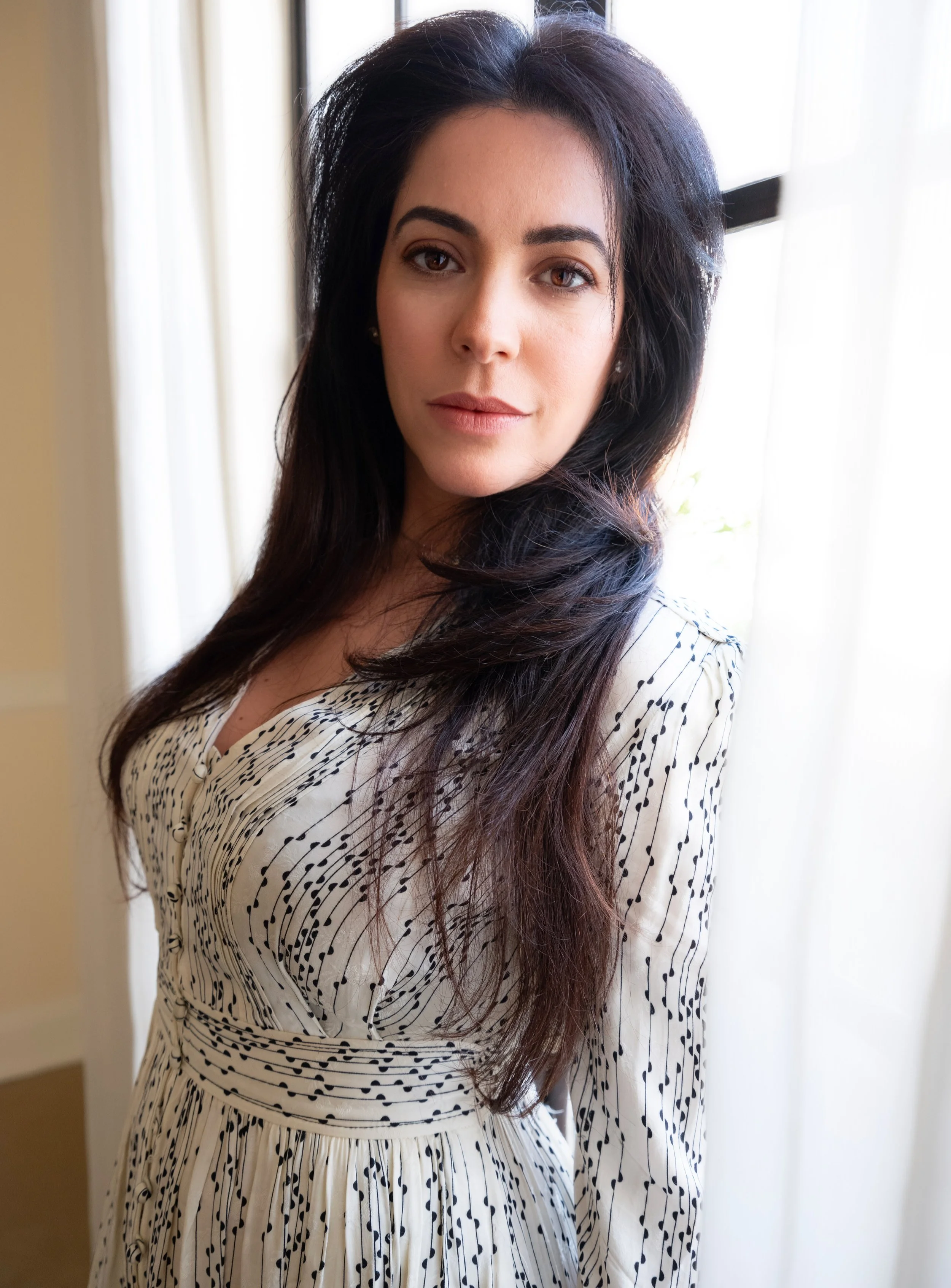  Maje Casben in a white dress, captured in soft natural light – editorial actor and model portfolio head shot in a Hollywood penthouse setting. 
