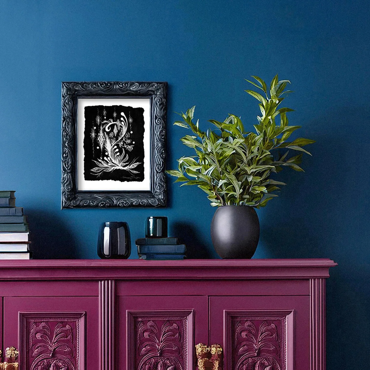 Black and white wall art with feathers, stars, flowers, abstract bird. Titled Proud Plumage. By Stacey Taylor. Shown in home.