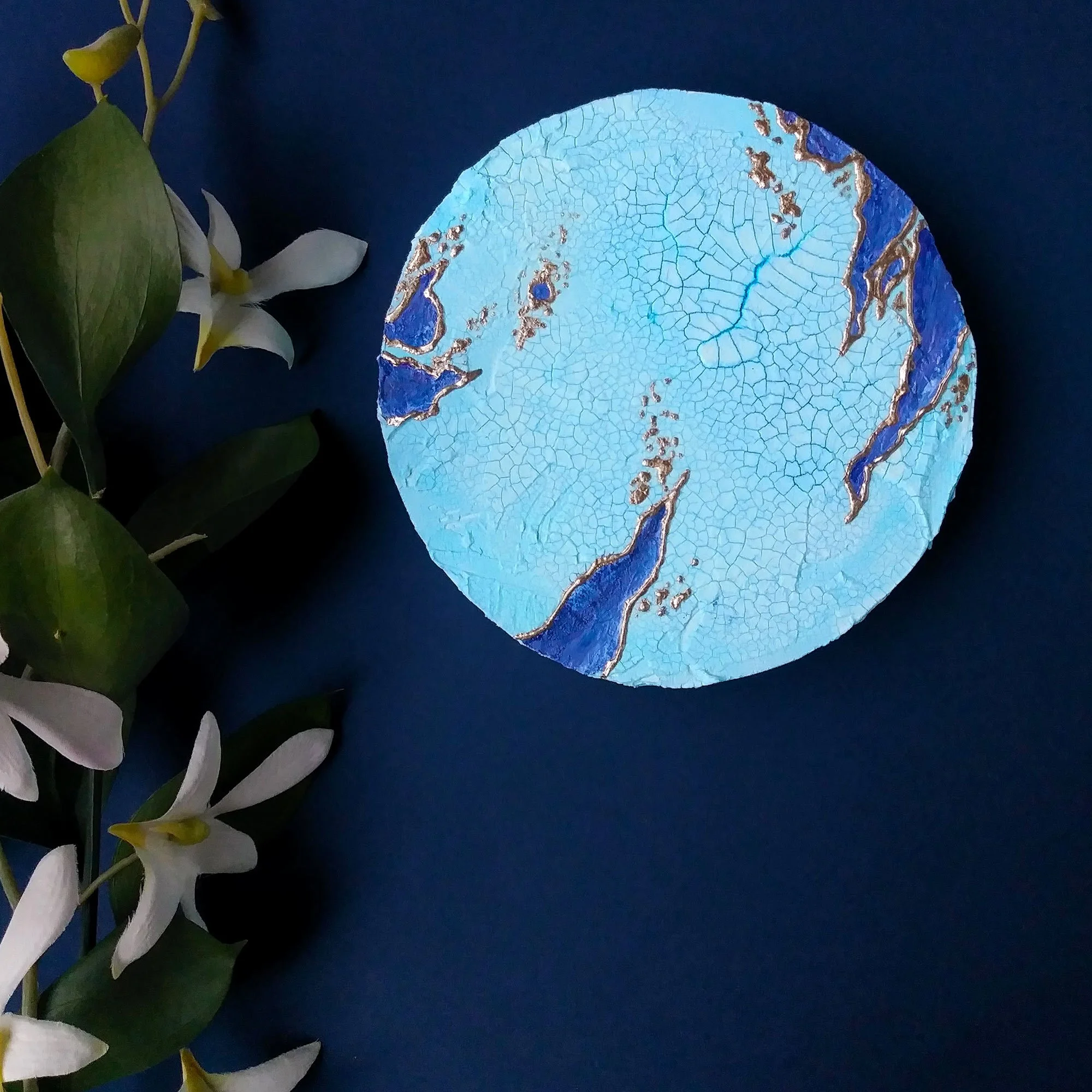Blue and purple textured abstract inspired by outer space. Small round signed one-of-a-kind. Titled Sabik. By Stacey Taylor.