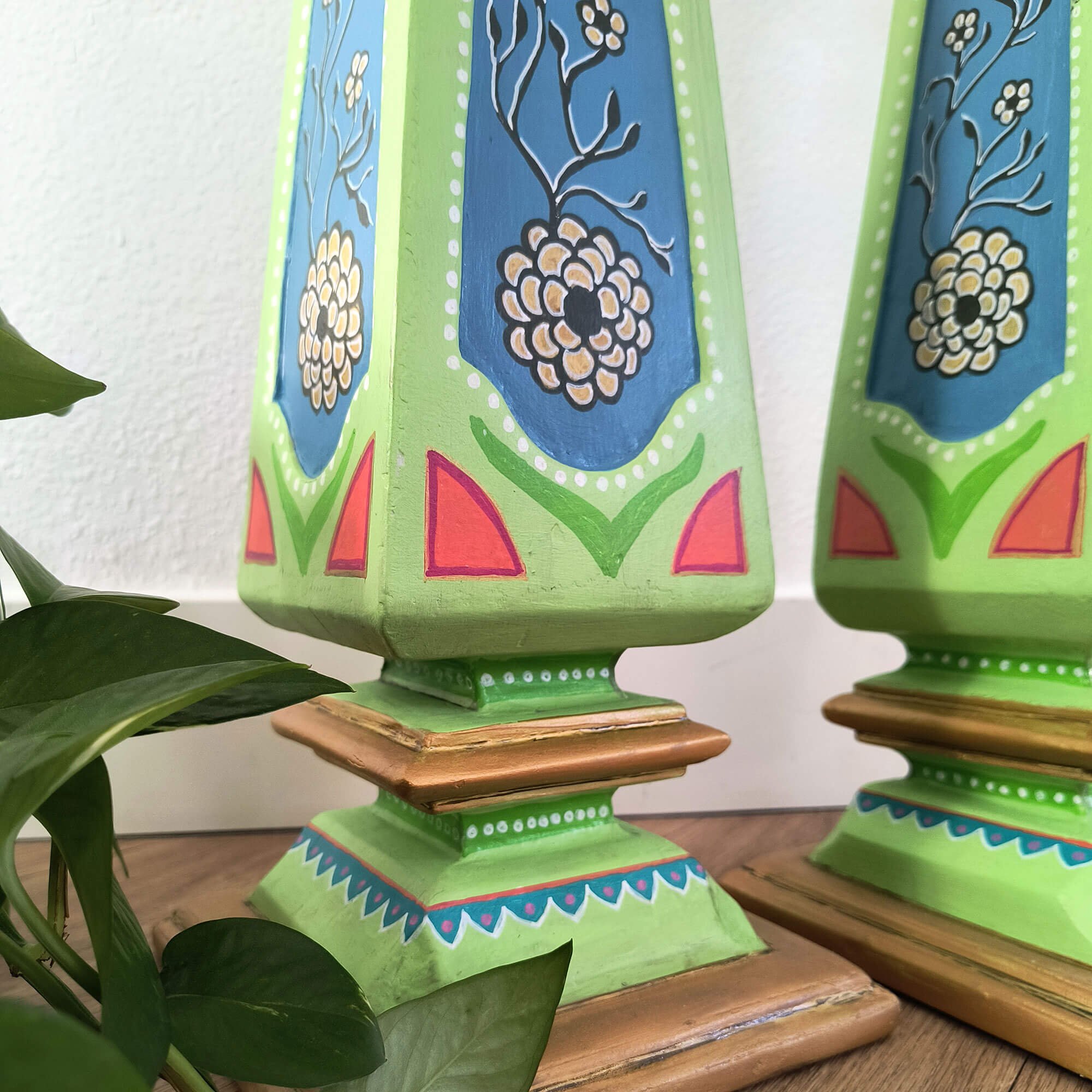 Colorful folk art furniture style decorative pedestals set, hand-painted by Stacey Taylor. Closeup view of floral detail.