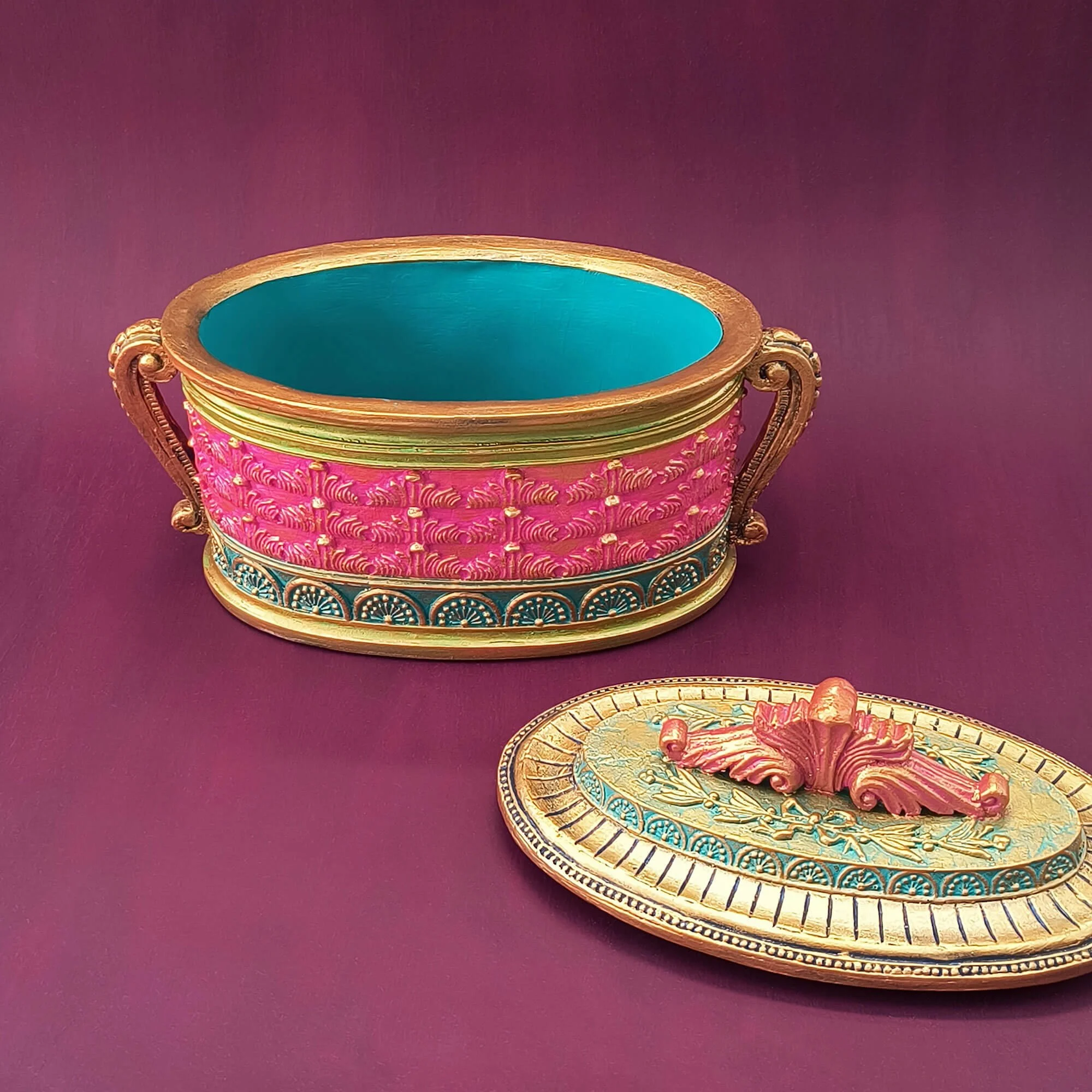 A decorative box with a whimsical fantasy style hand-painted in colorful hues and accented in metallic gold. By Stacey Taylor. Viewed with lid open.