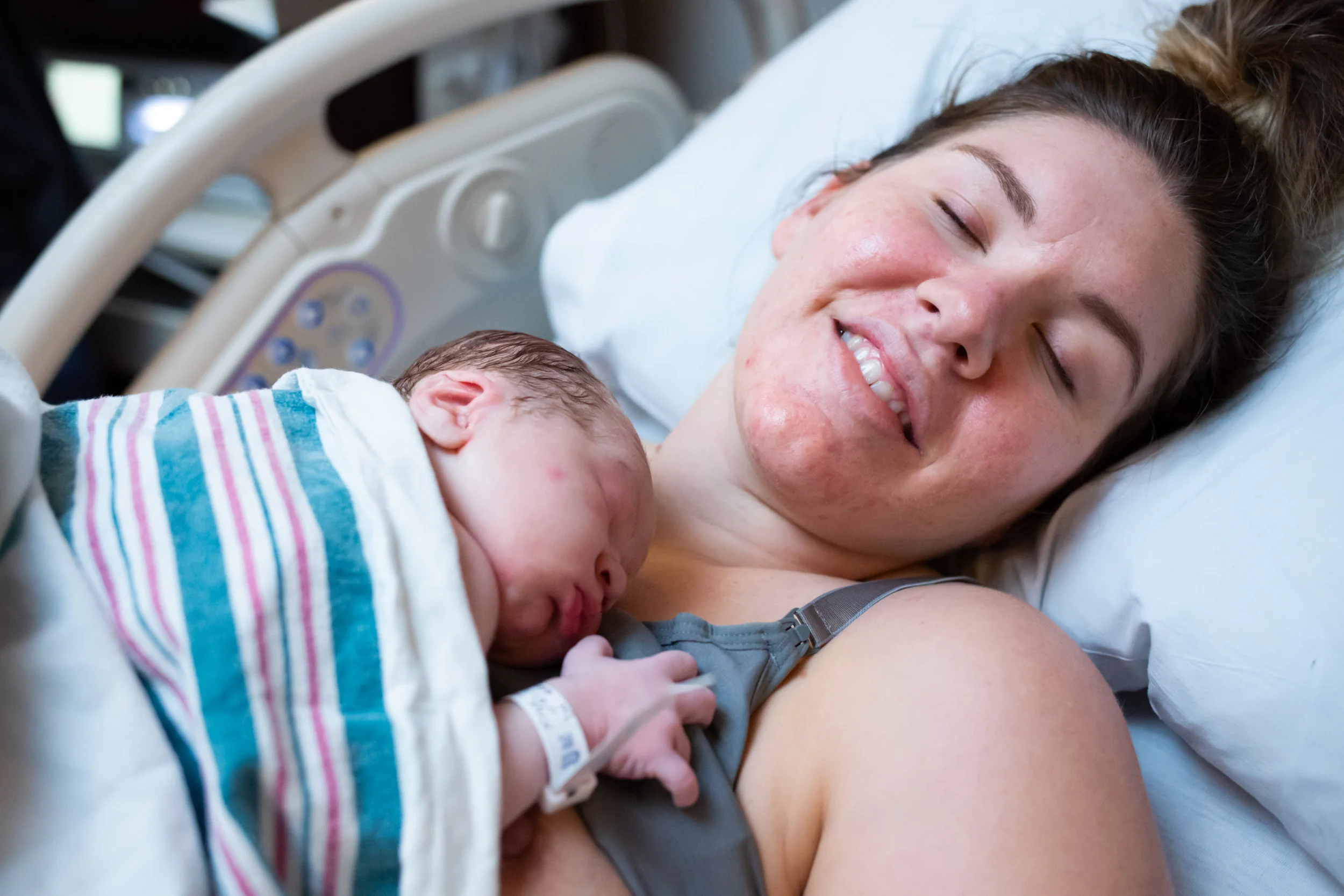 mom holds baby boy just after birth