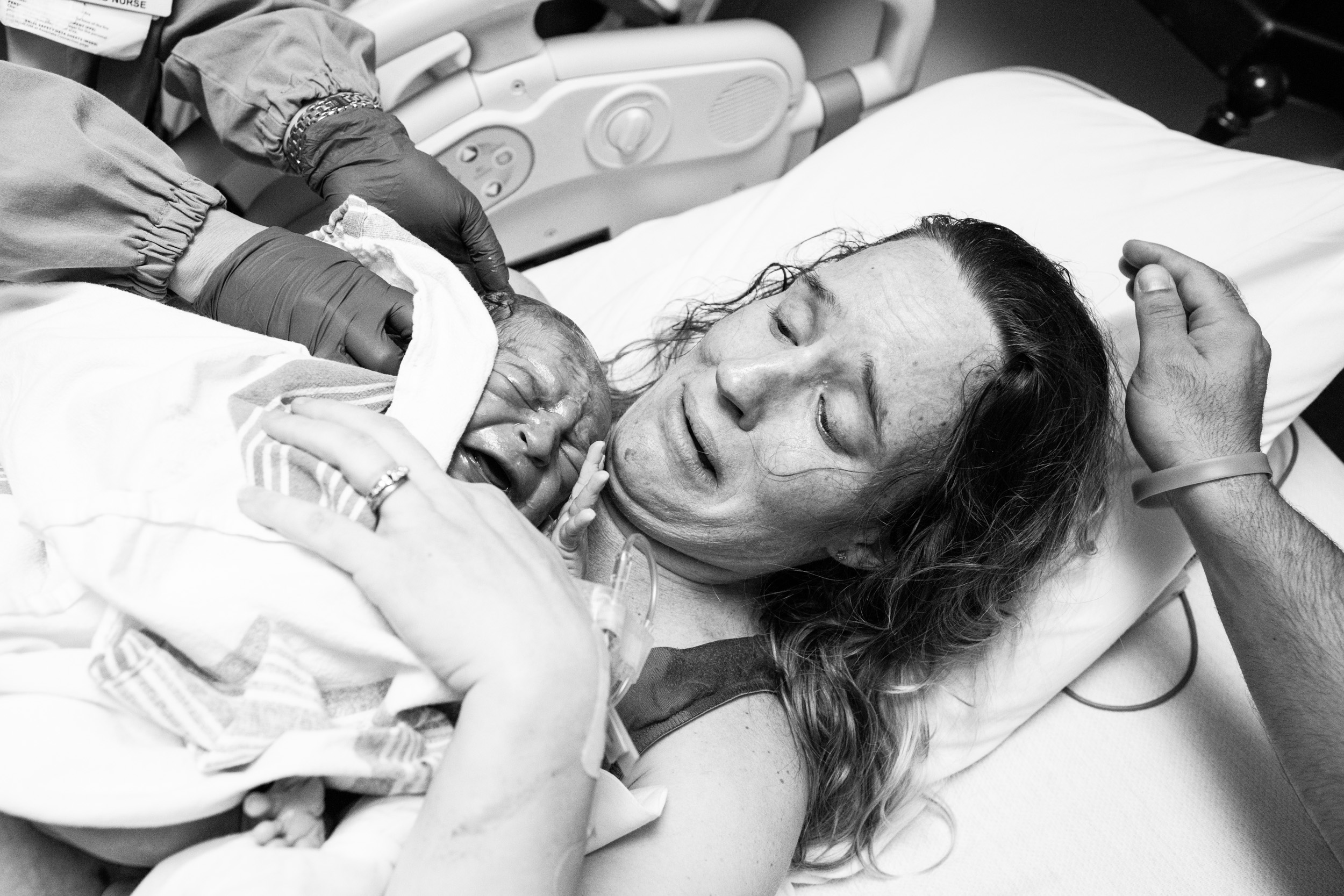 mom cries as she holds her baby for the first time