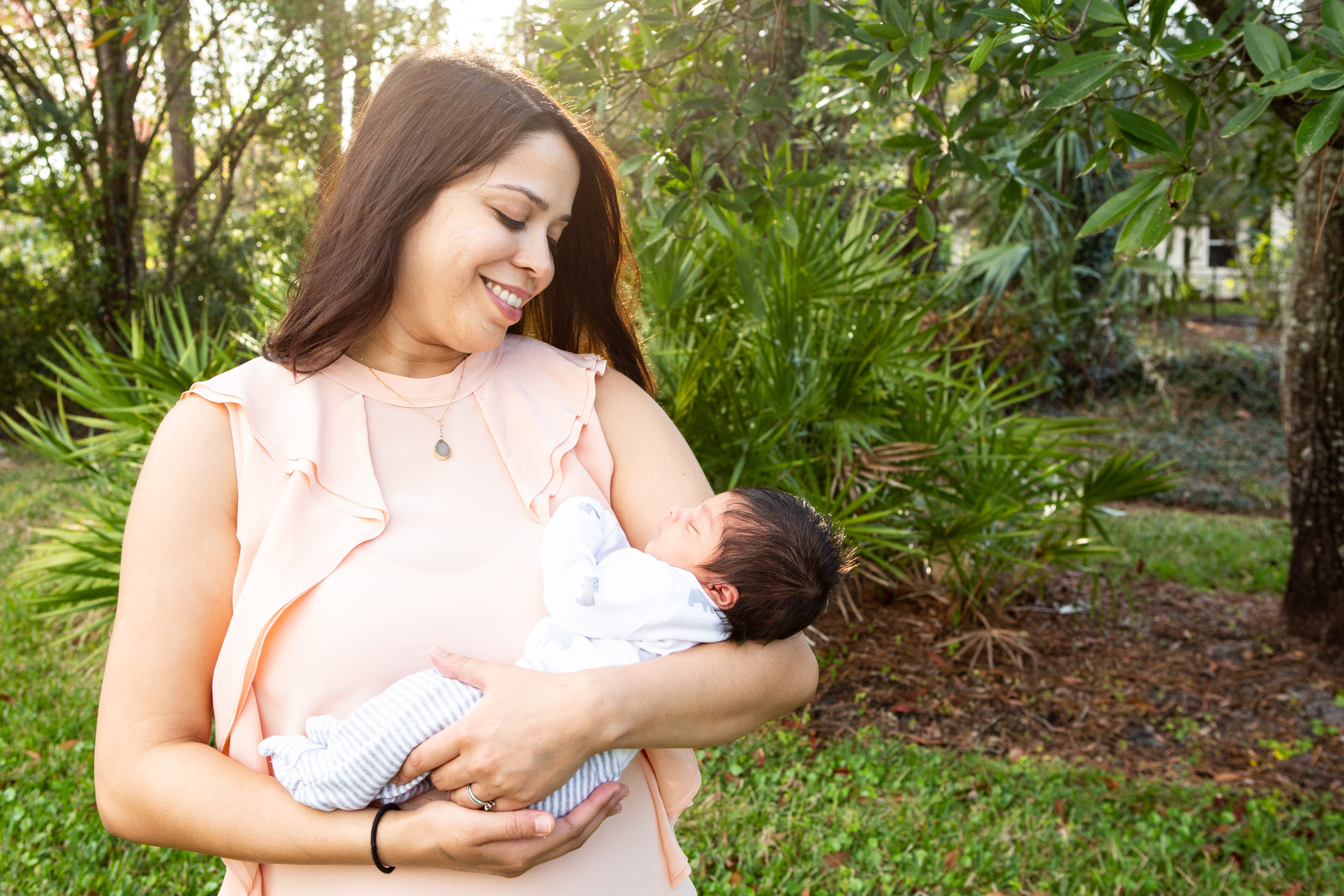 mom holding her newborn and smiling