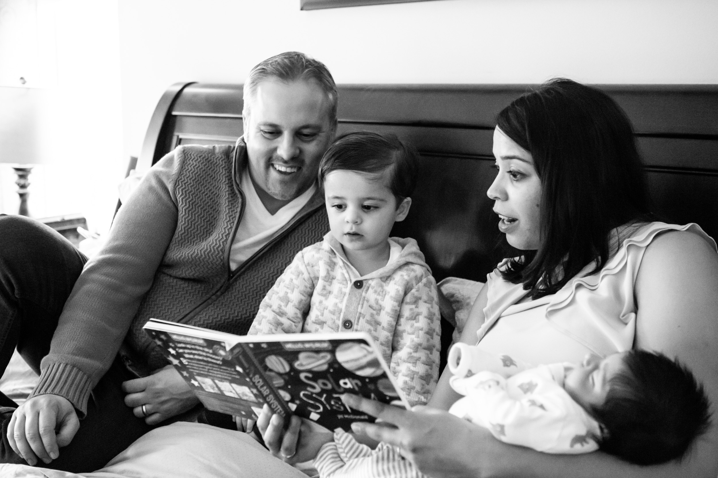 family of 4 reading together
