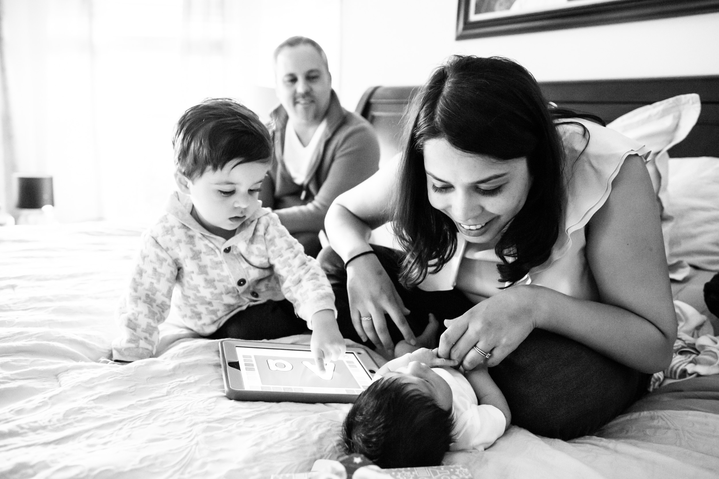 mom smiling at newborn baby boy