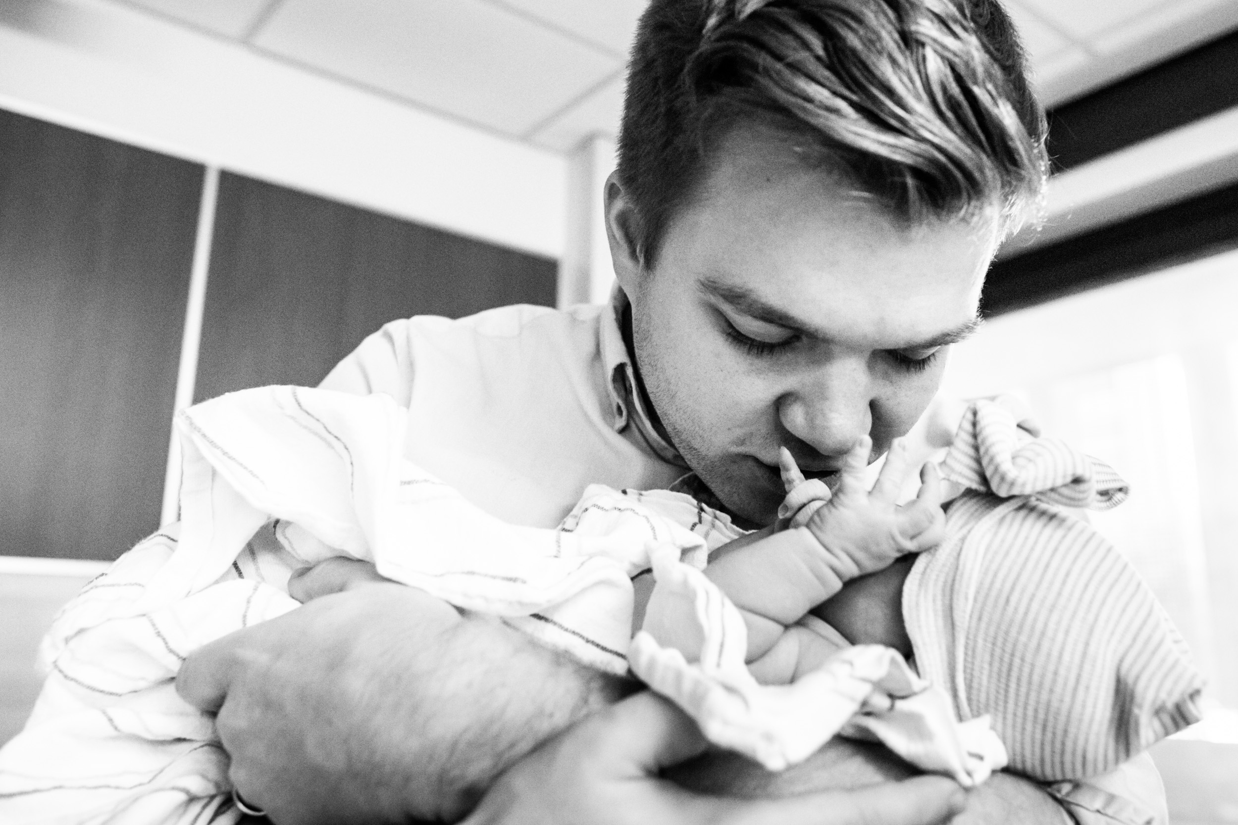 new dad kissing his baby girl