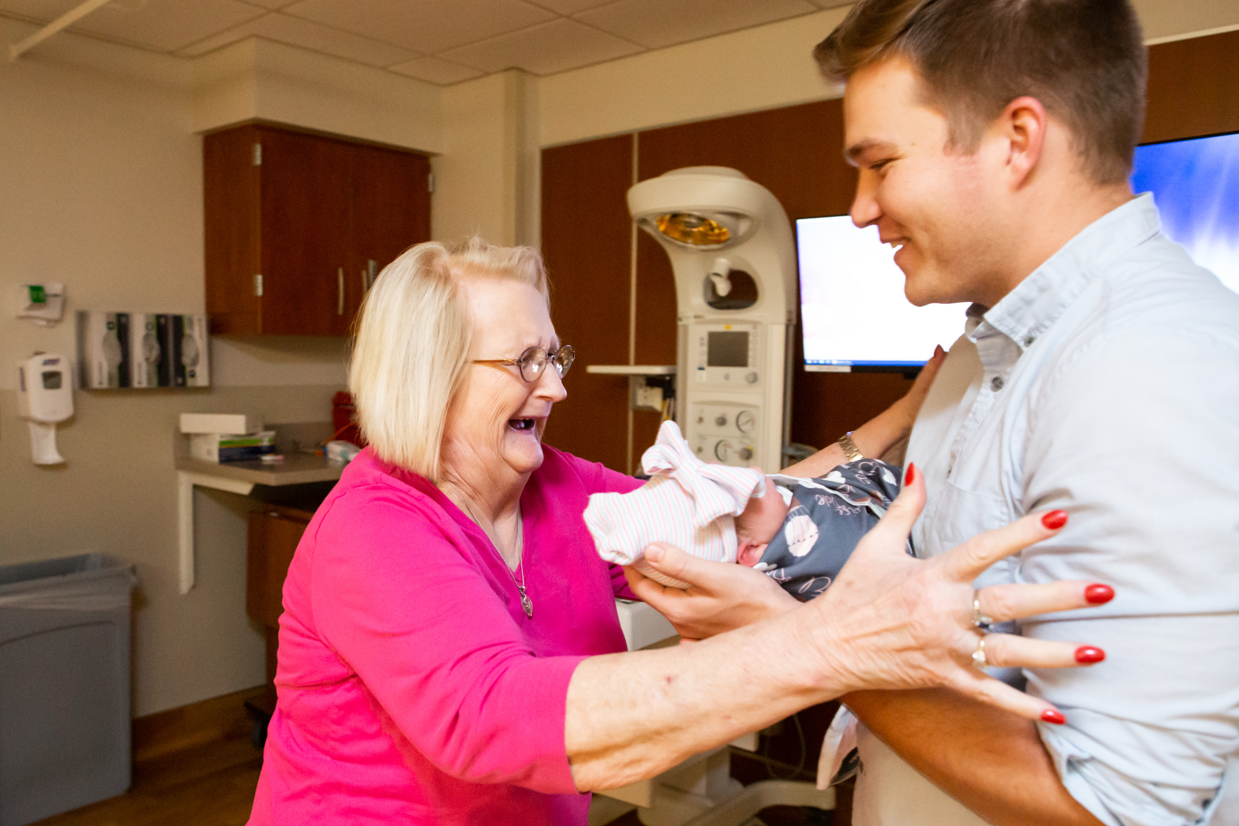 great-grandmother running to her grandson and newborn baby