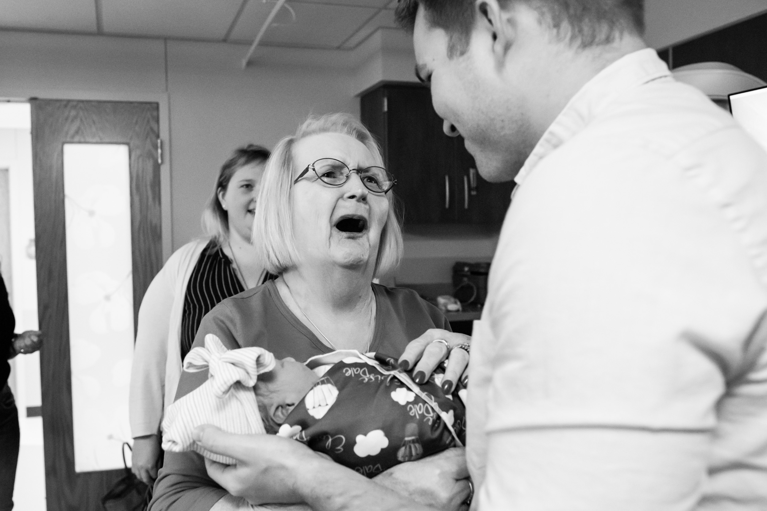 great-grandmother crying with joy after realizing baby's middle name is her late husband's name