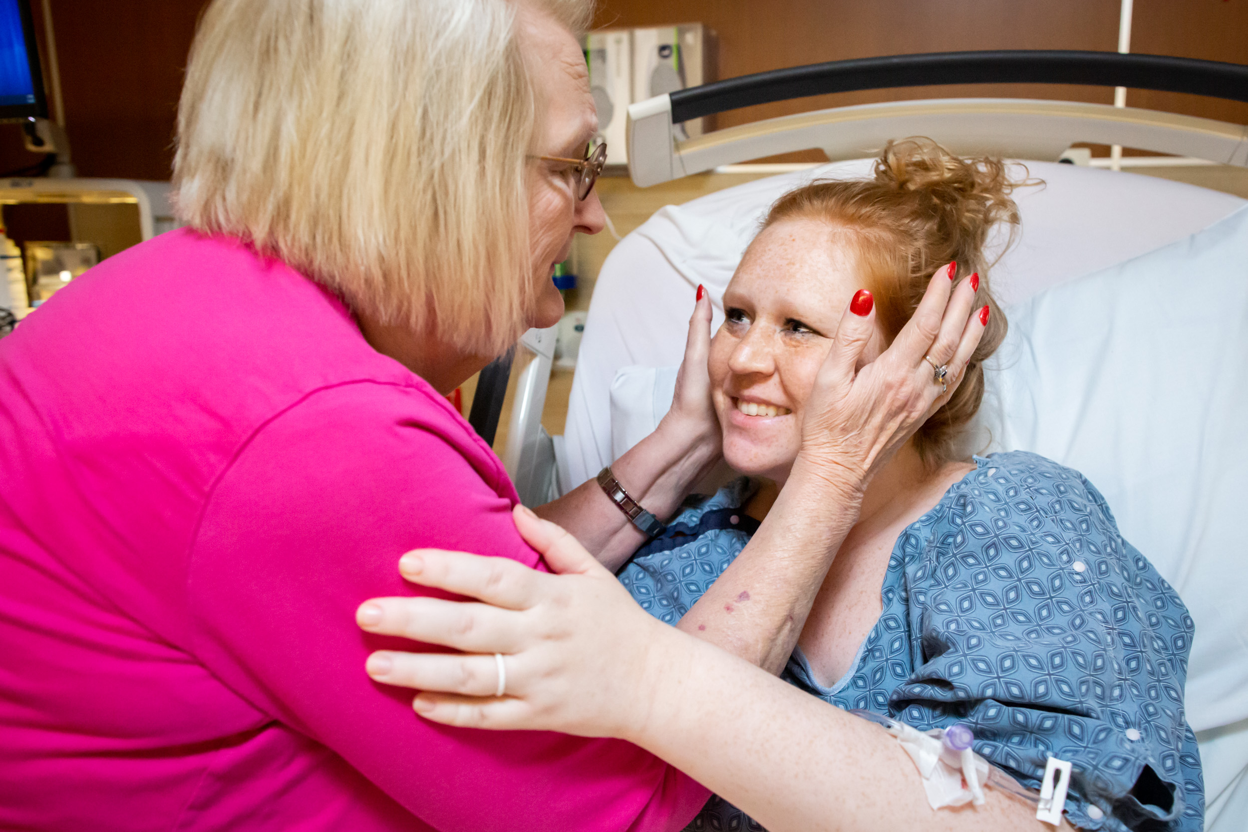 great-grandmother holding the face of her granddaughter-in-law after birth