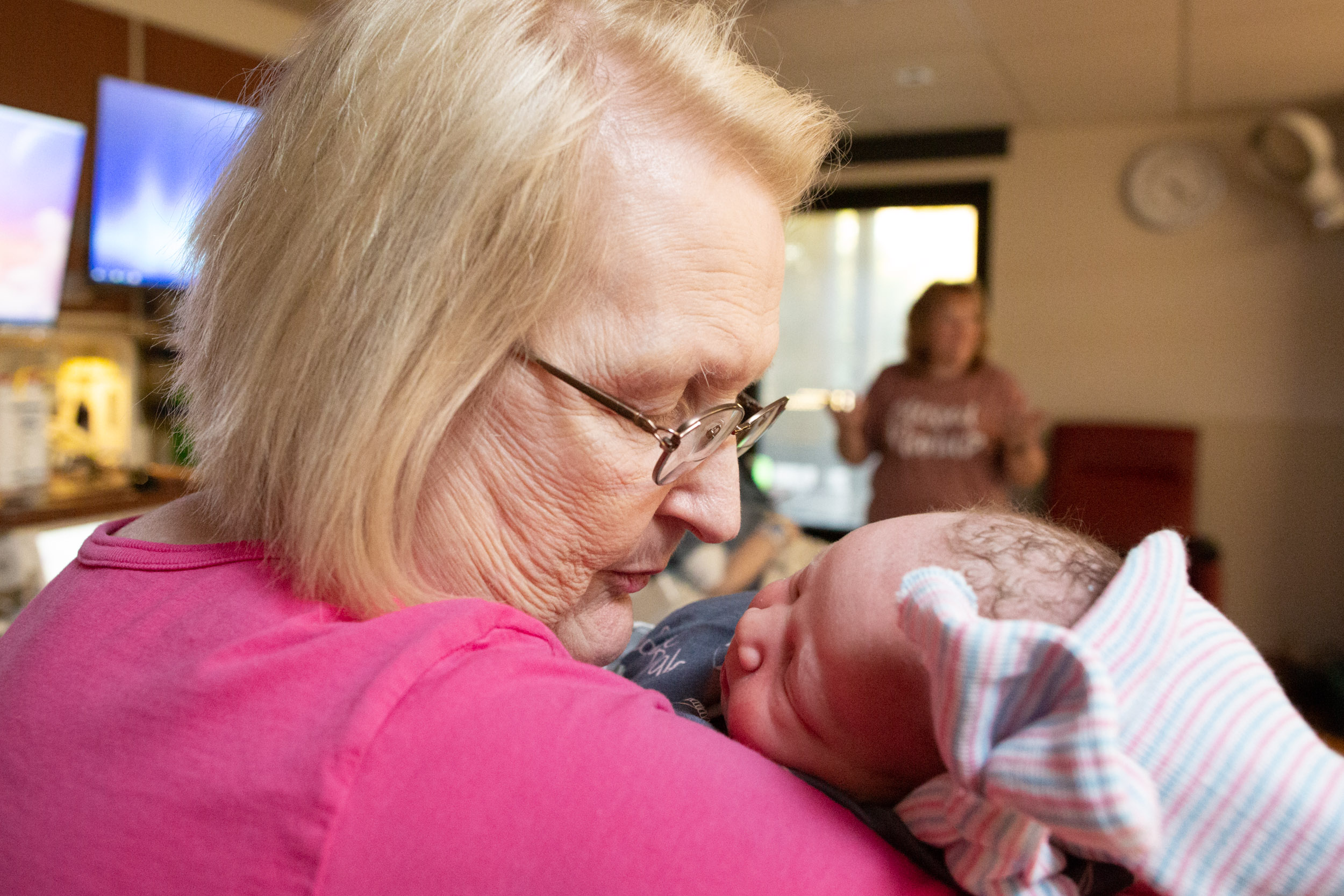great-grandmother holding newborn baby girl