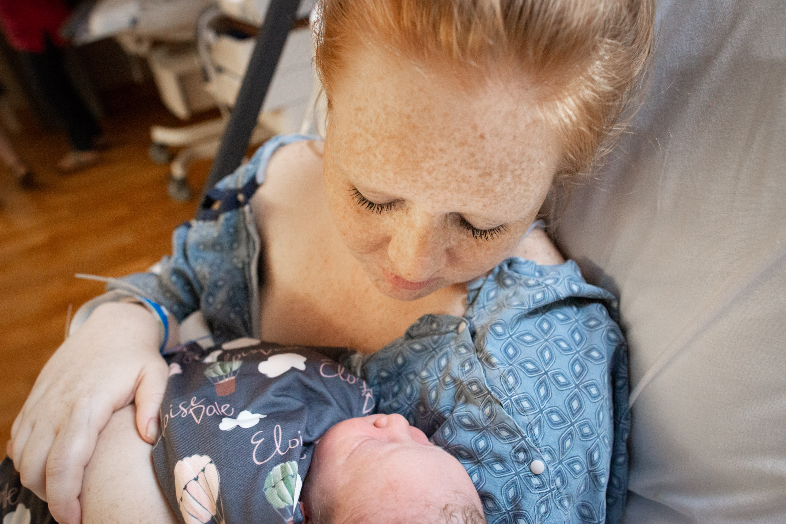 mom looking at her newborn baby girl