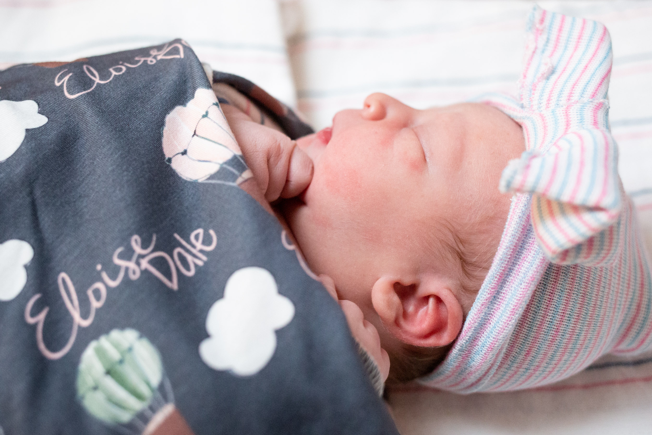 sweet baby wrapped in blanket with her name on it