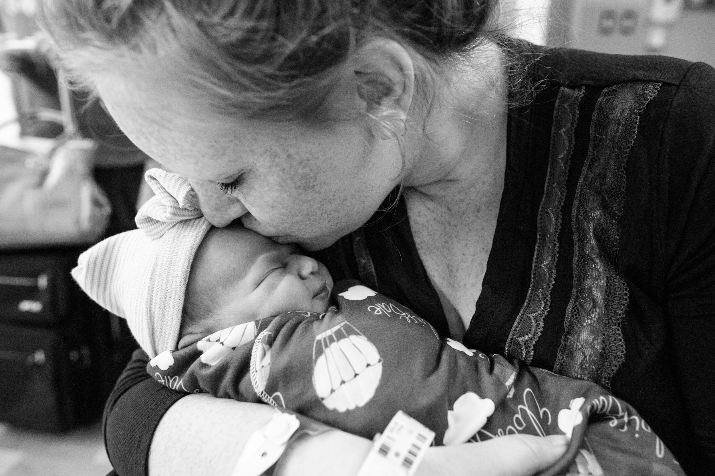new mom kissing her baby girl