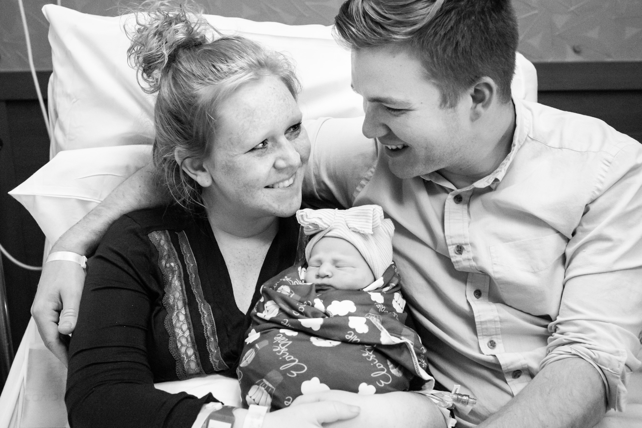 gainesville parents looking at each other after bringing a new baby into this world