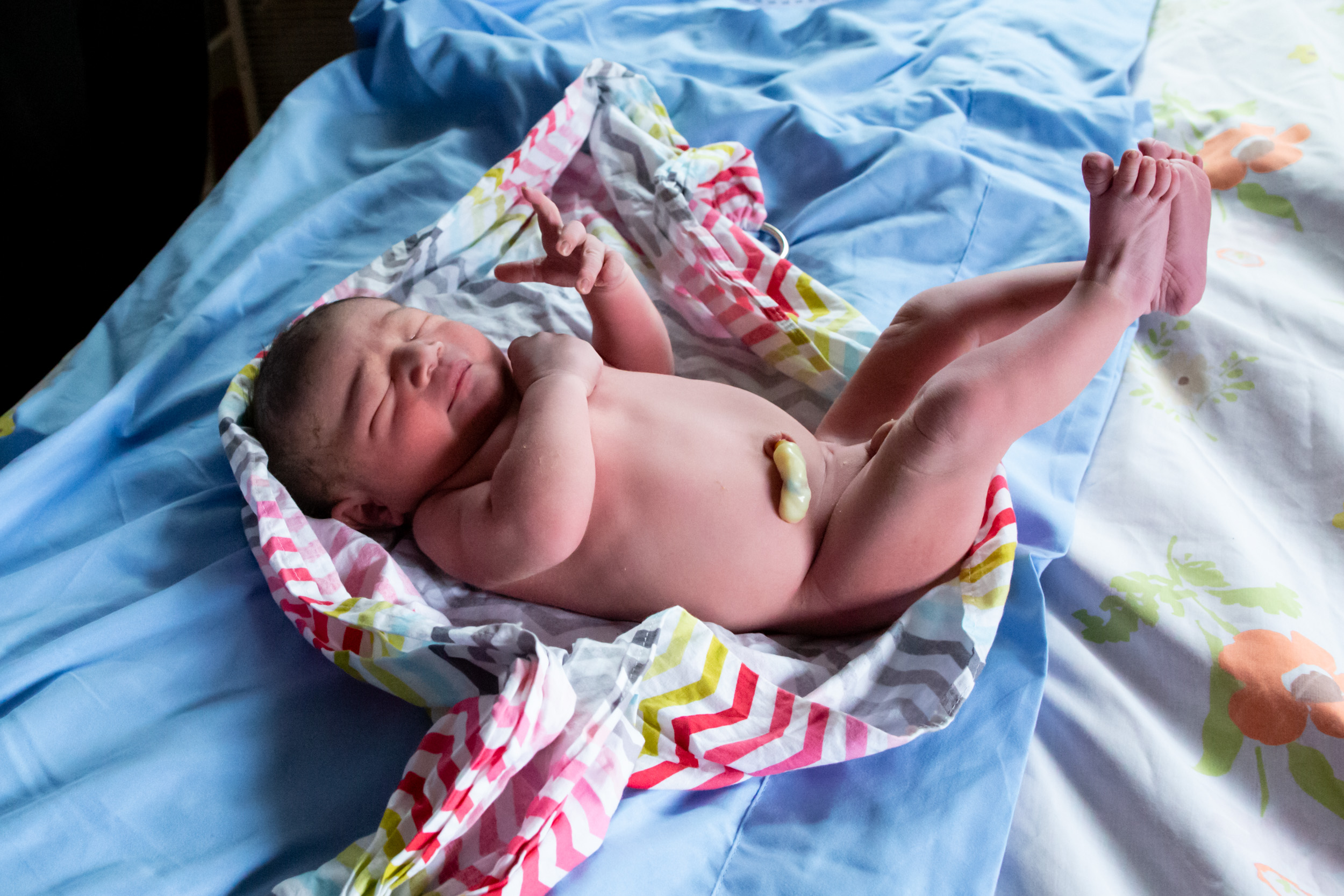 newborn baby boy laying on bed