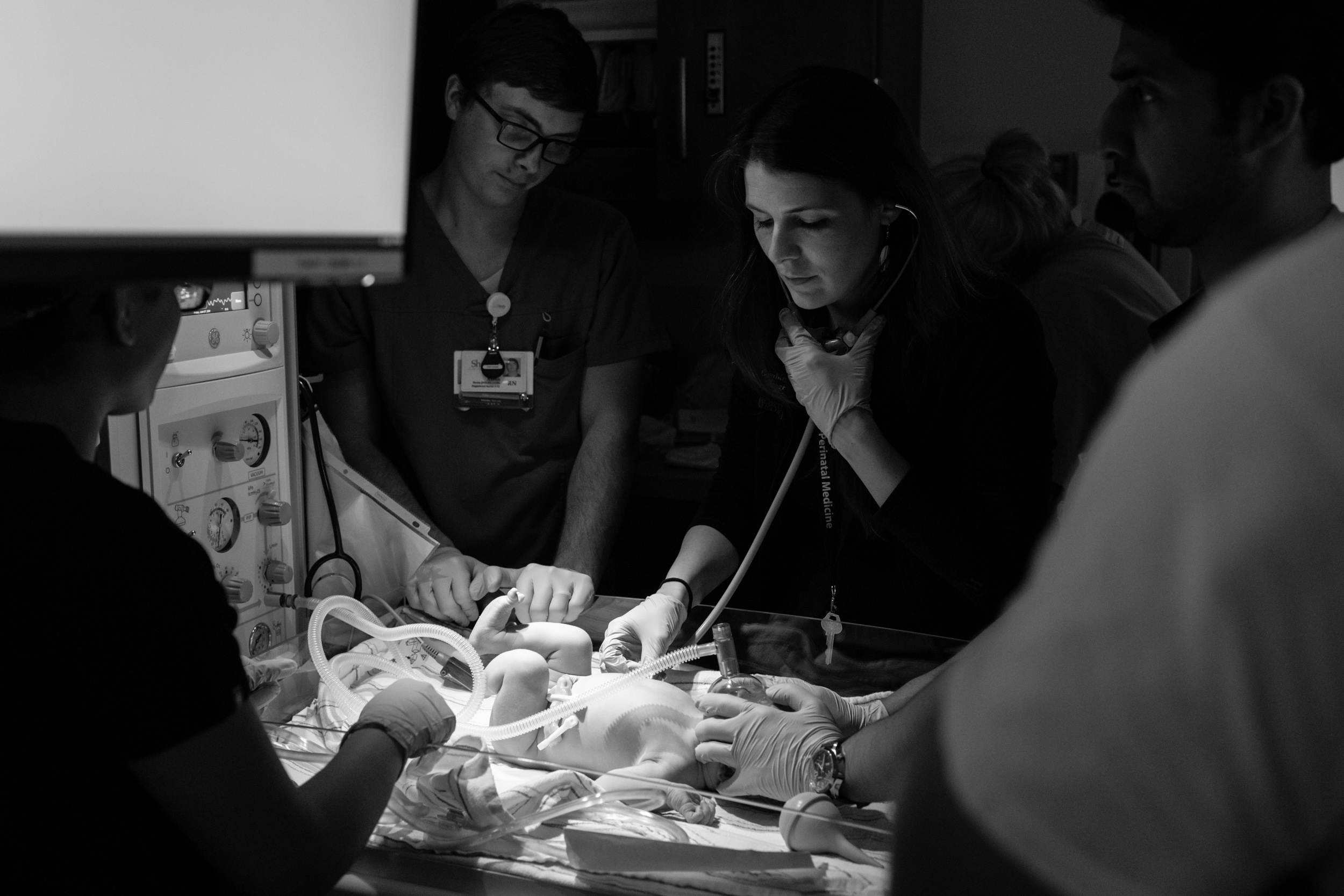 pediatrician checking lungs of newborn baby boy