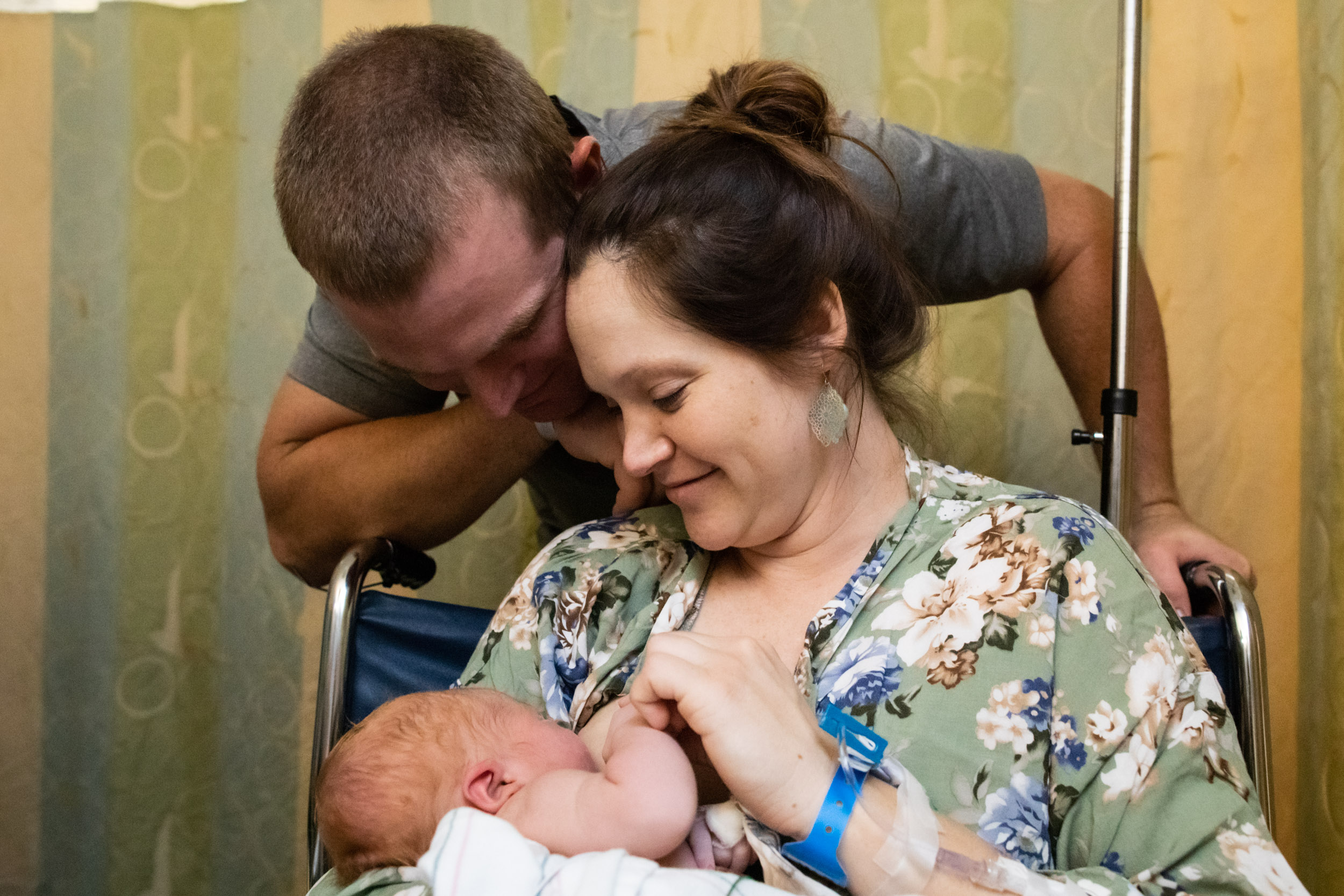 new parents looking on at their sweet baby boy in the nicu