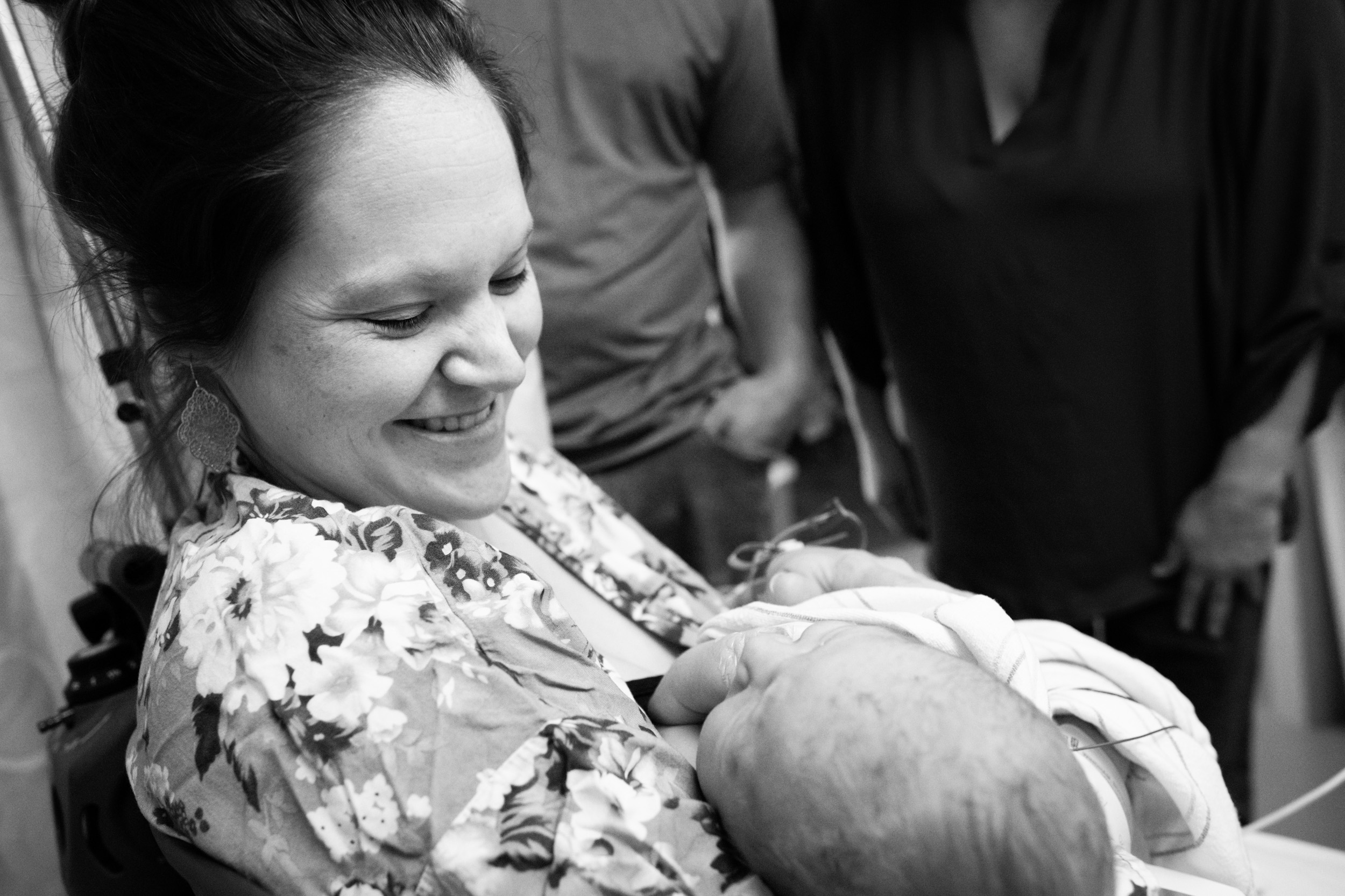 gainesville mom smiling at her newborn baby boy