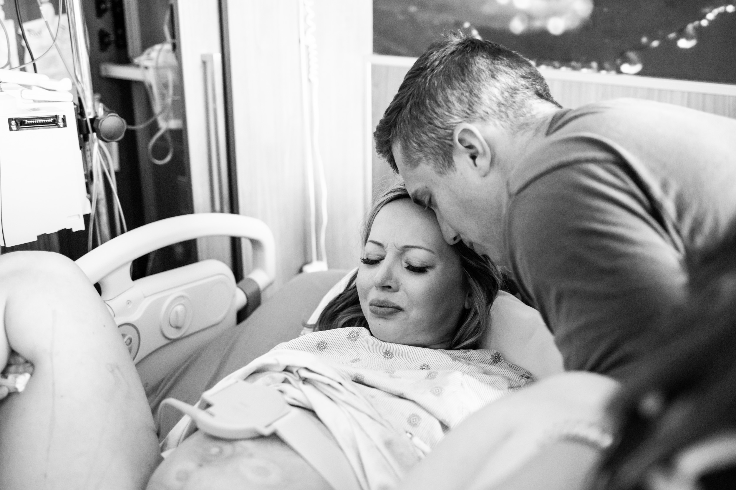 husband helping his wife push during a contraction