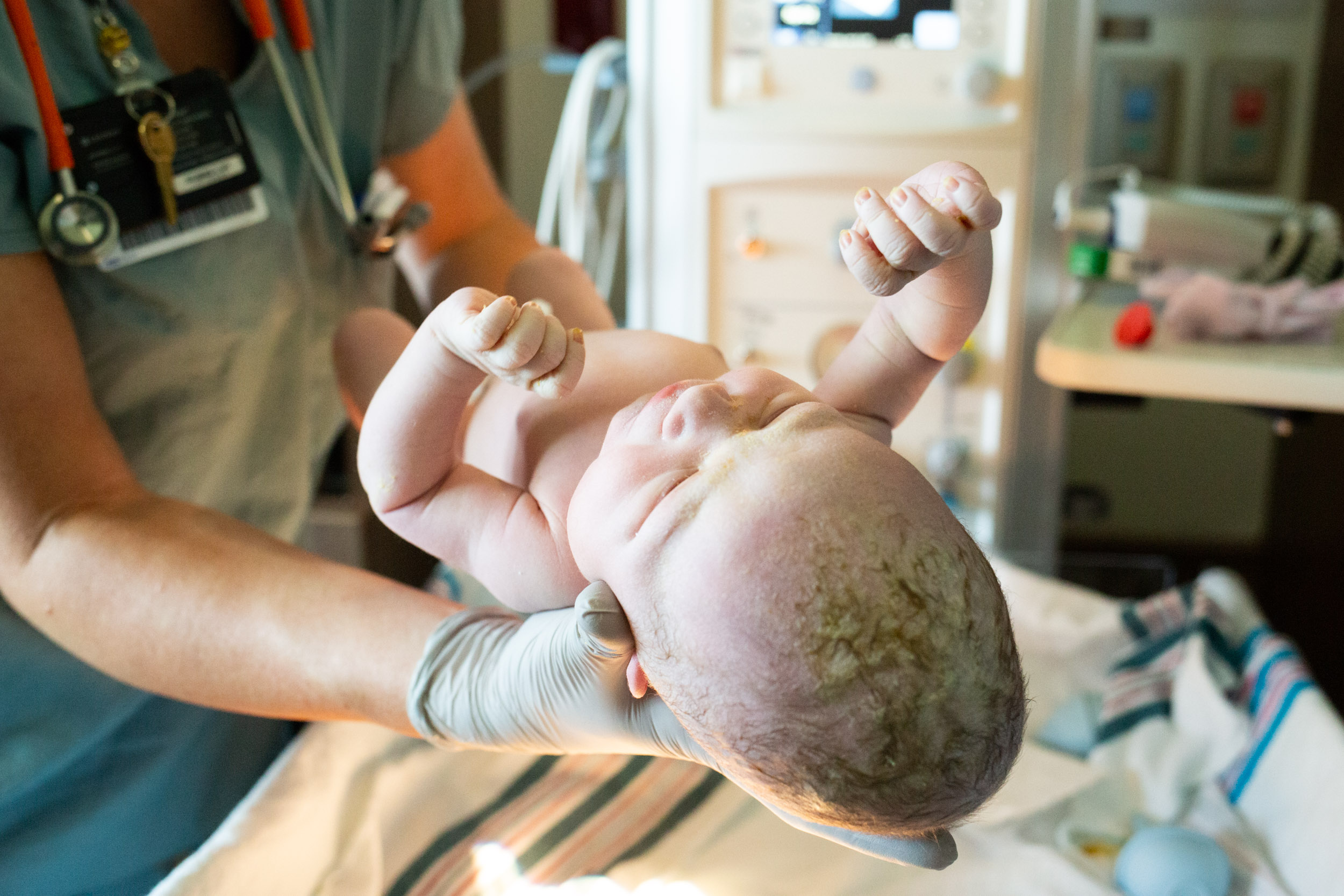 newborn baby being assessed by medical team