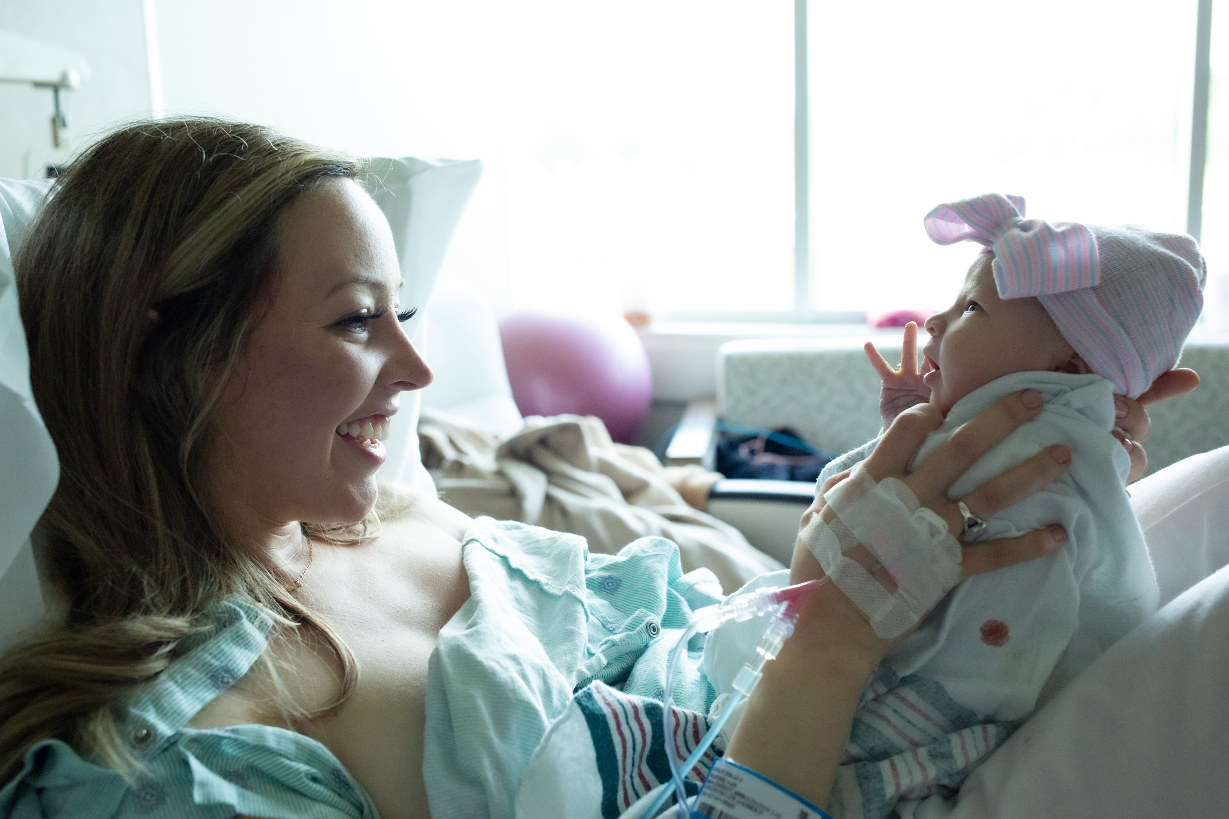 jacksonville mom holding up newborn baby girl