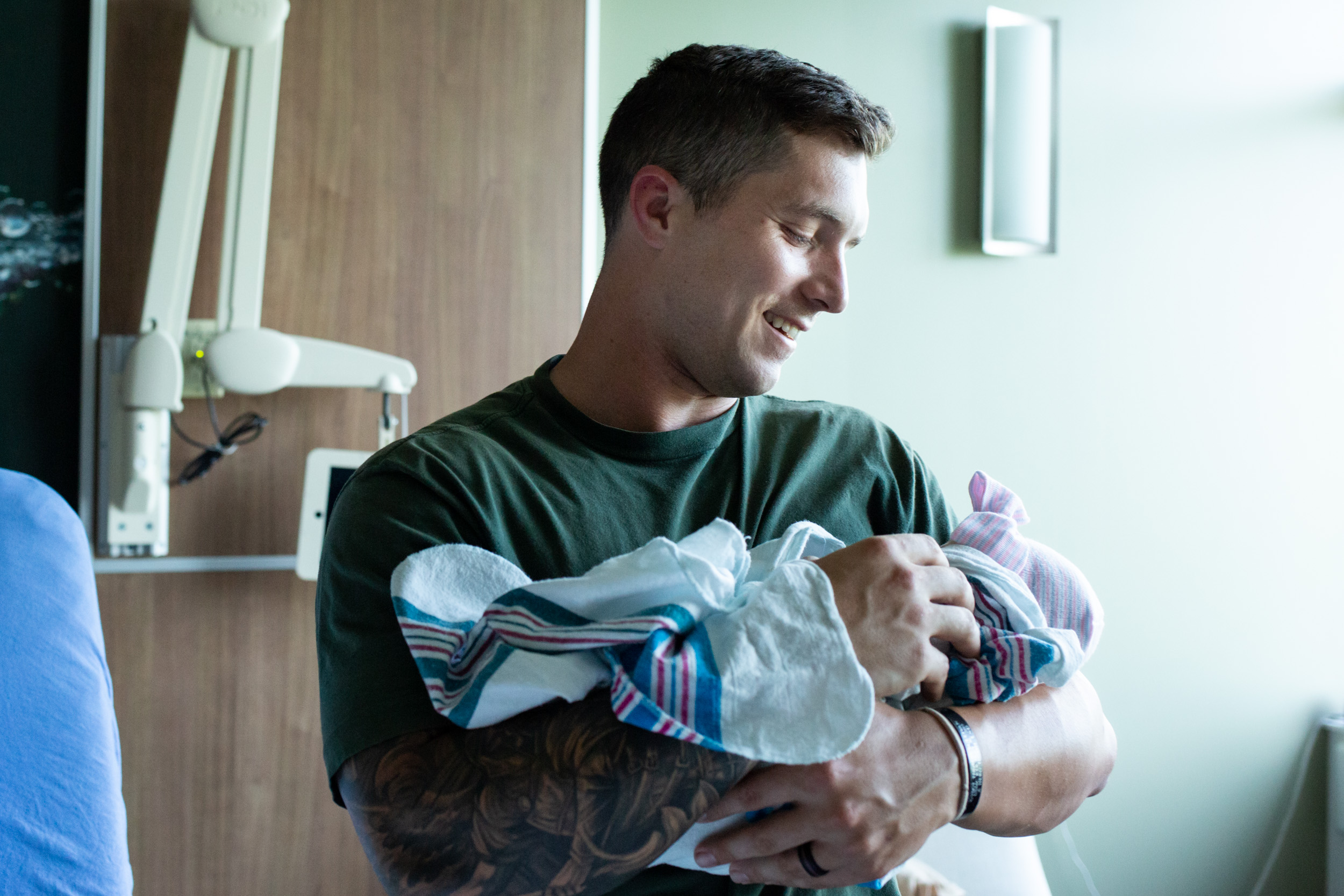 jacksonville birth dad smiling at newborn baby girl