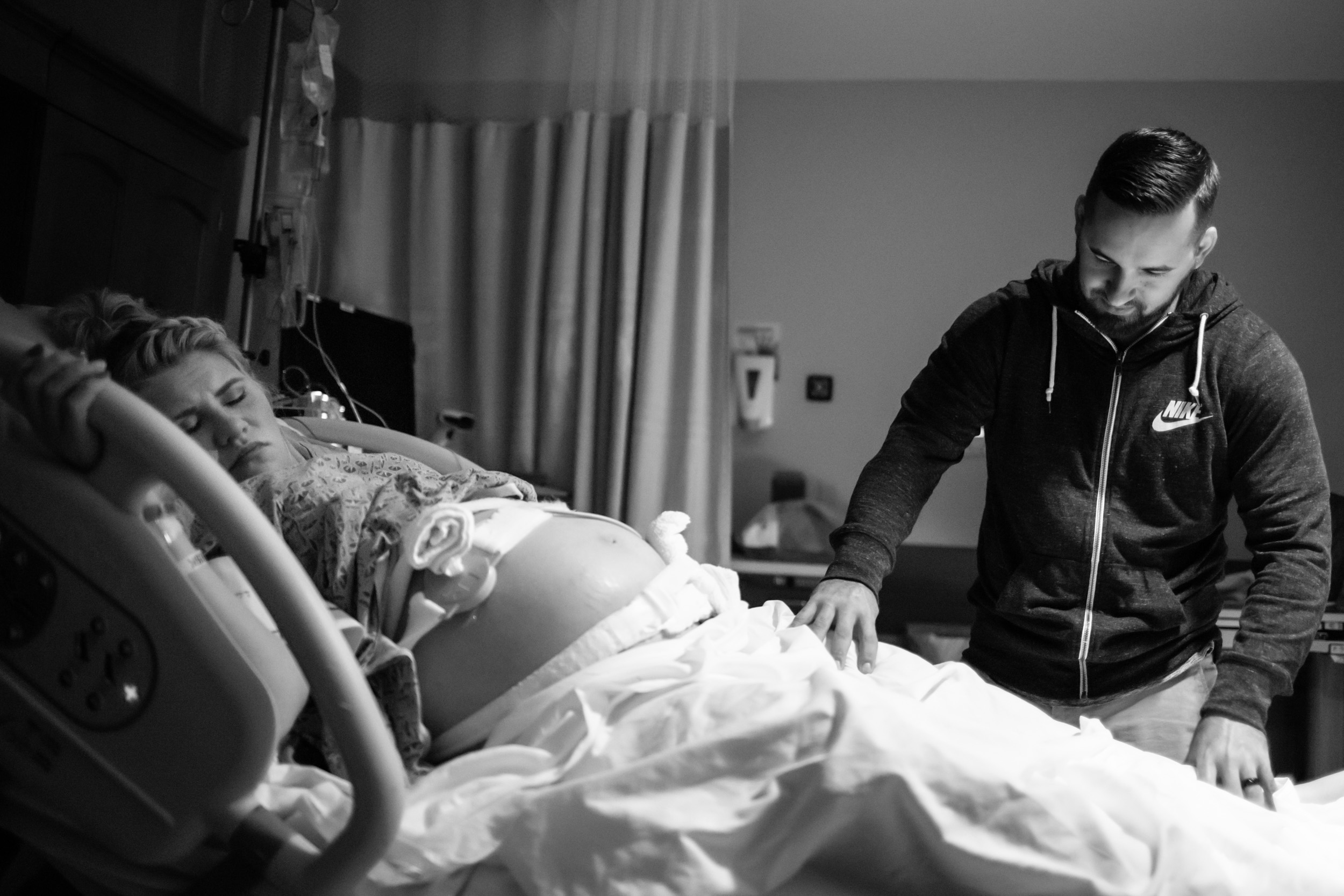 husband rubbing wife's leg while she is in labor