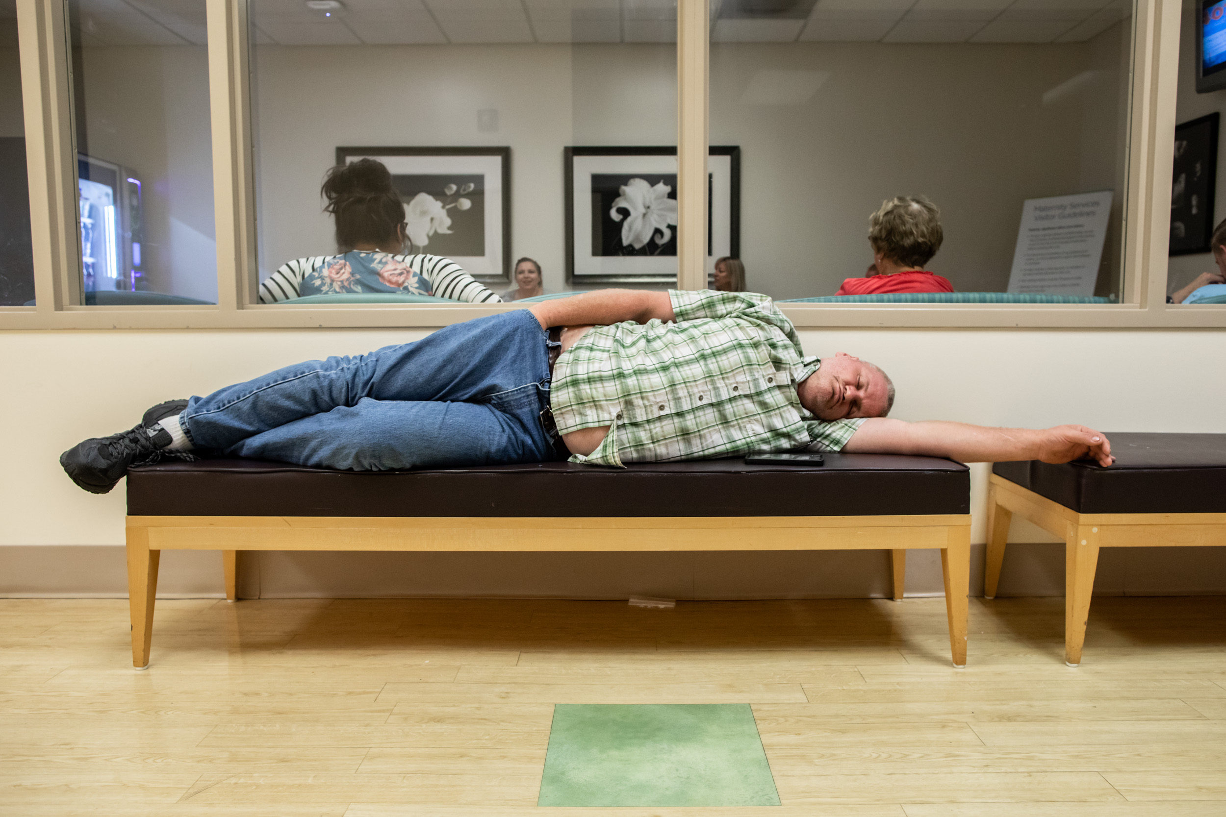 grandfather sleeping on bench while waiting for grandsons to be born