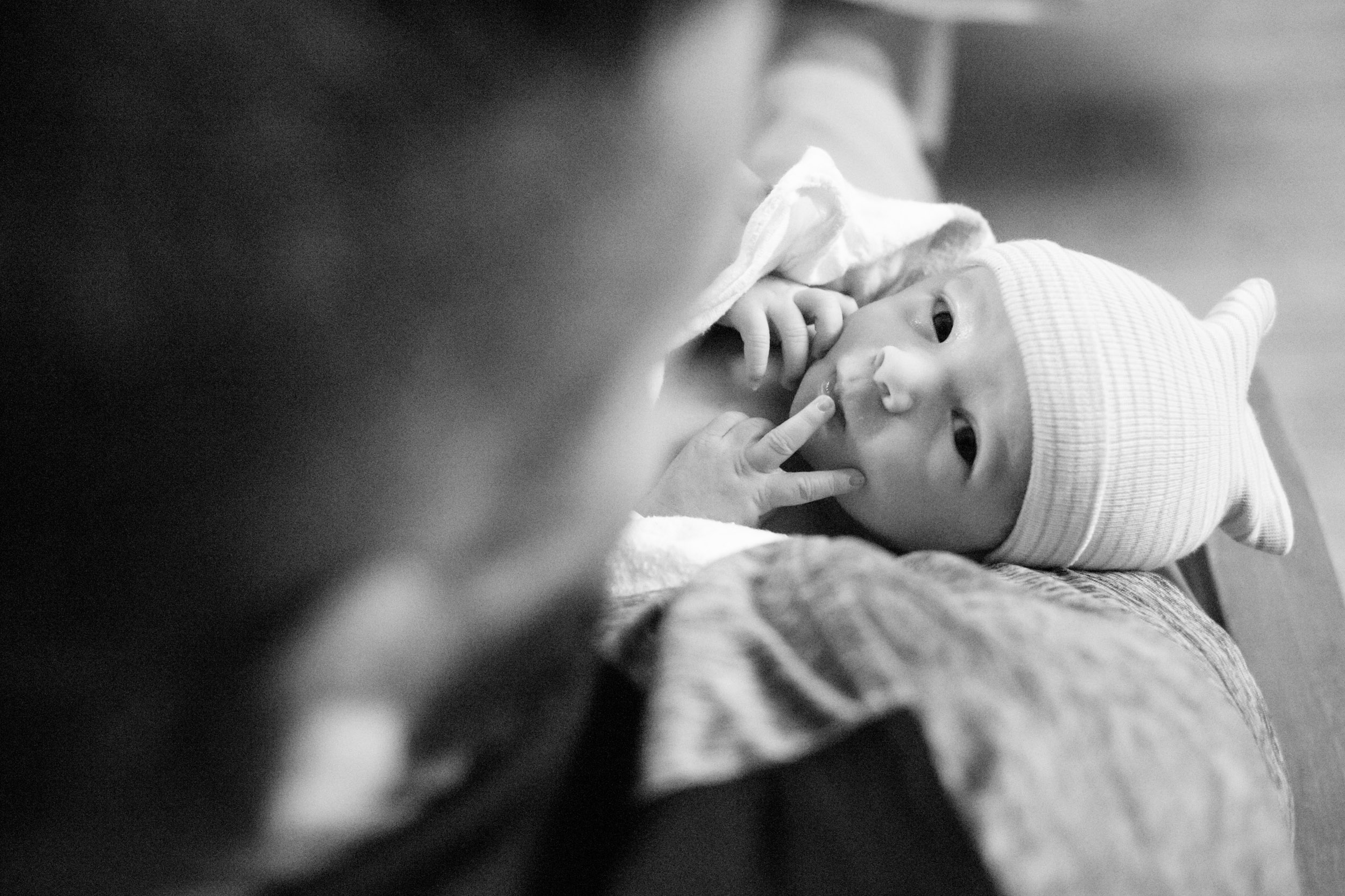 newborn baby looking up at the camera