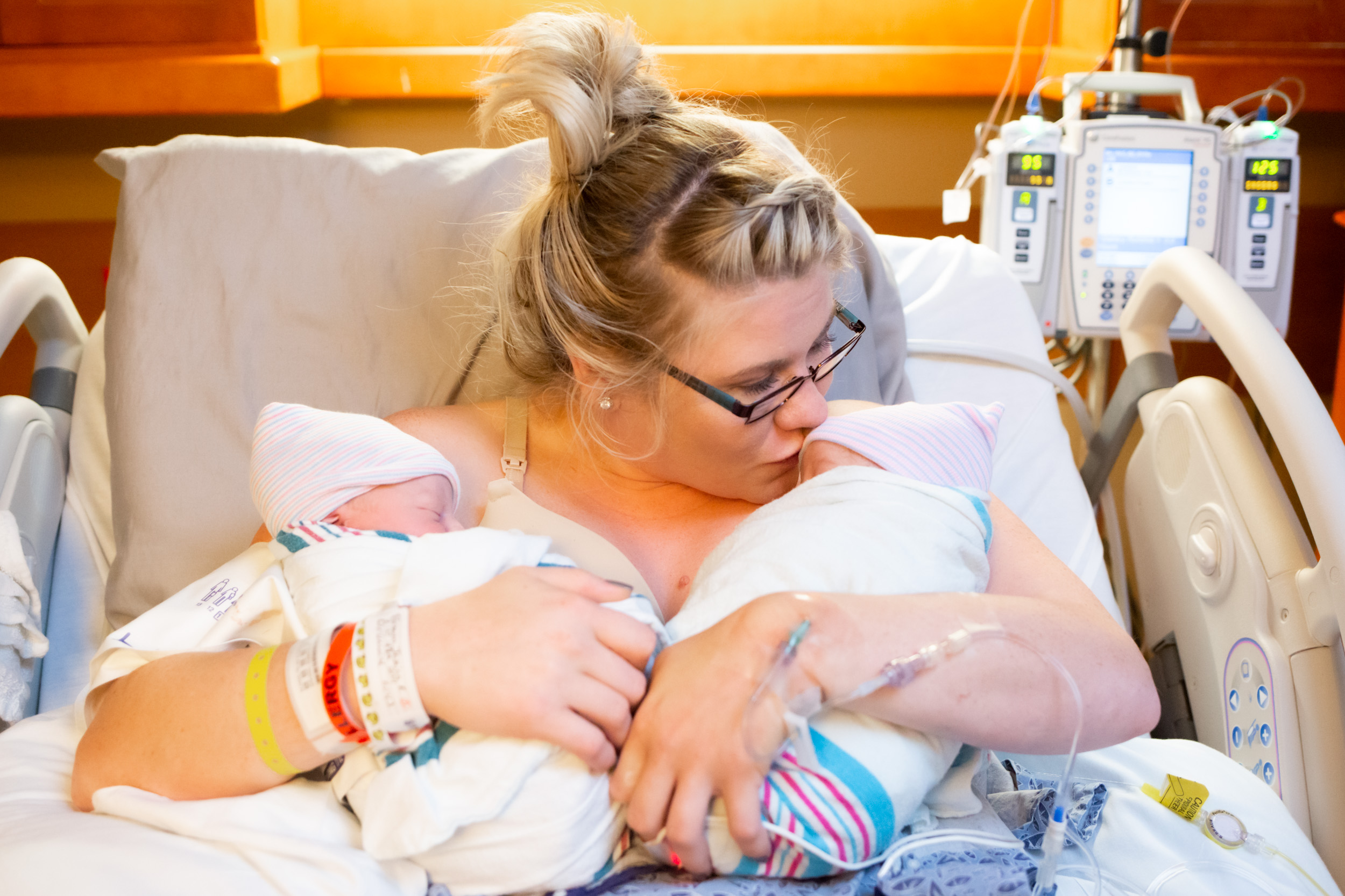 mom kissing one of her twin boys