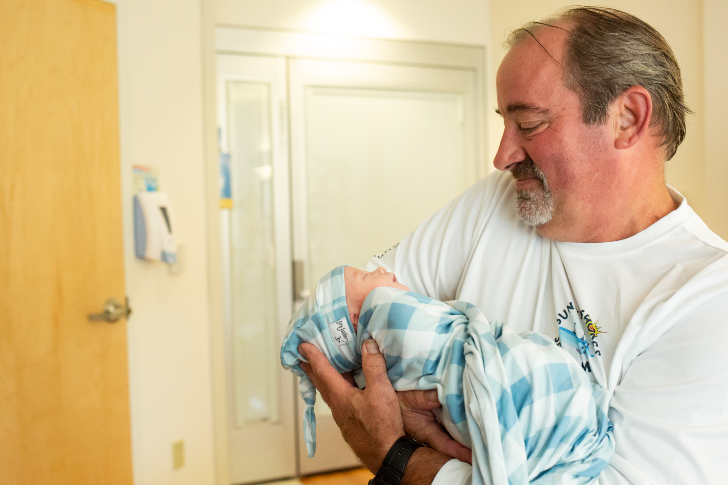 new grandfather holding newborn baby