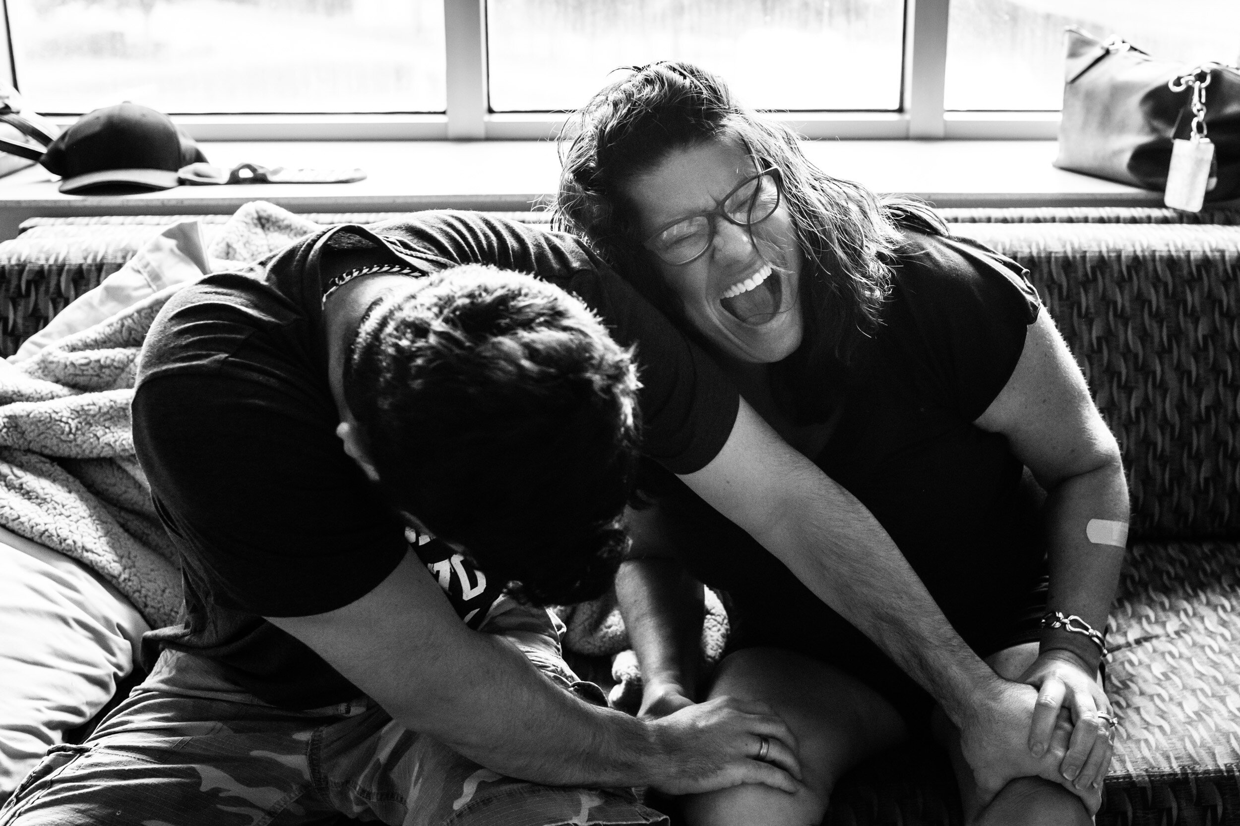 son and mom goofing off in hospital while waiting for baby to be born