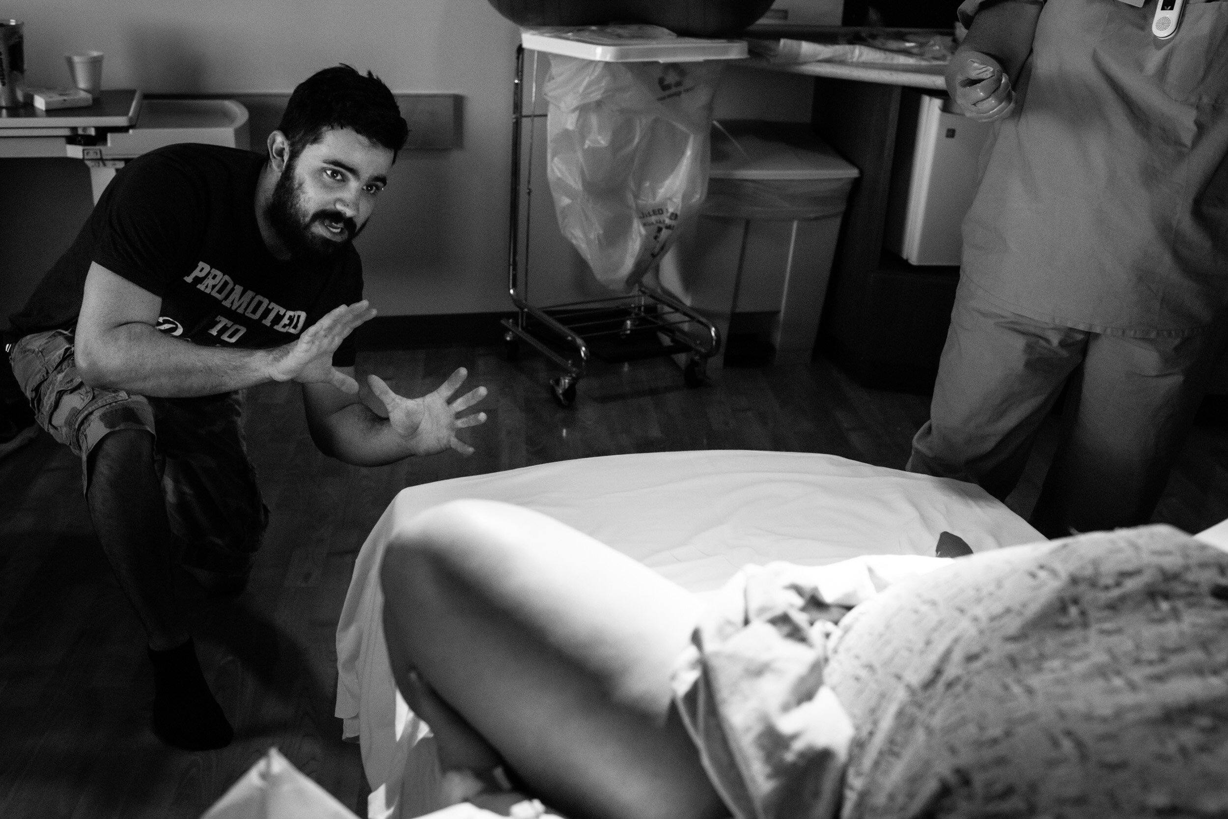 husband preparing to catch baby in a joking way