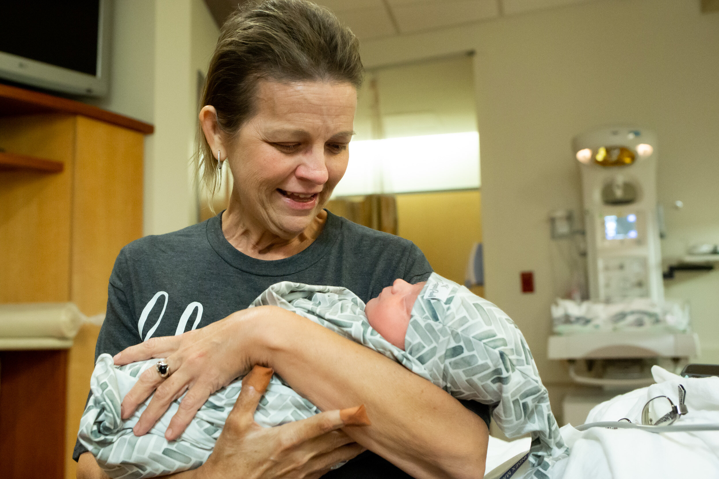 new grandma holding her grandson for the first time