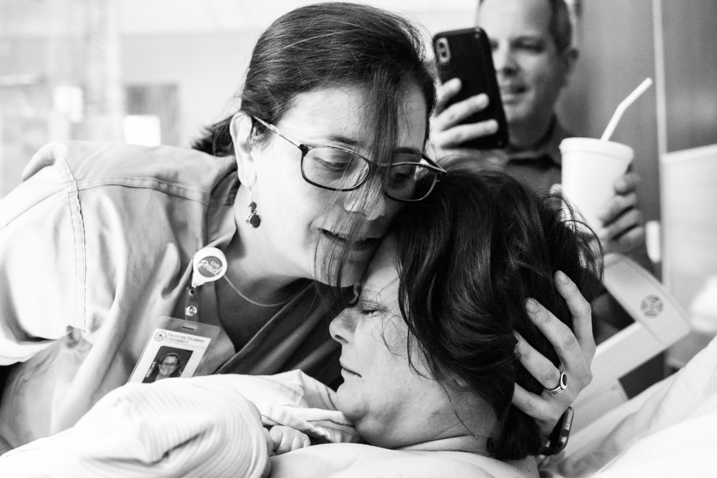 midwife hugging mom just after birth
