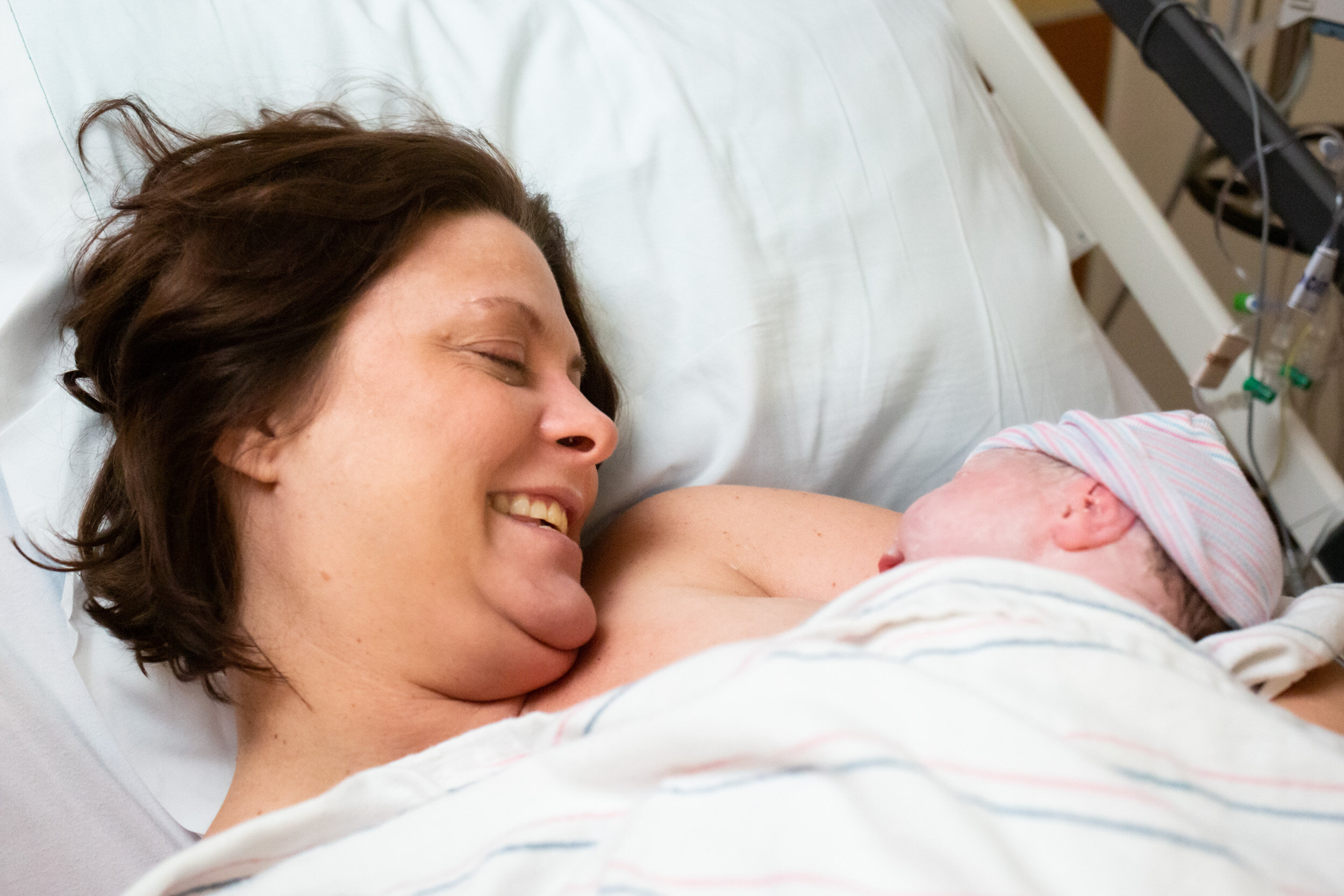 gainesville mom admiring her newborn baby