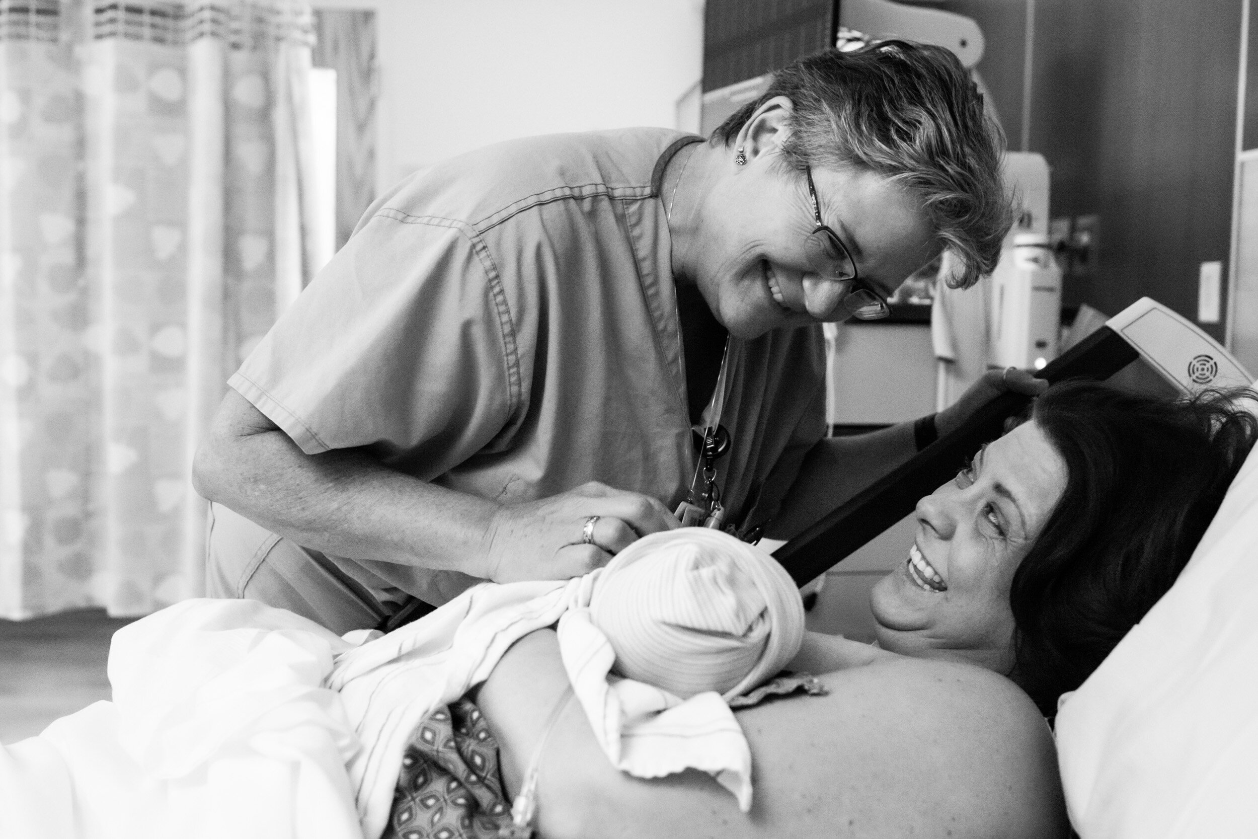nurse smiling at new baby