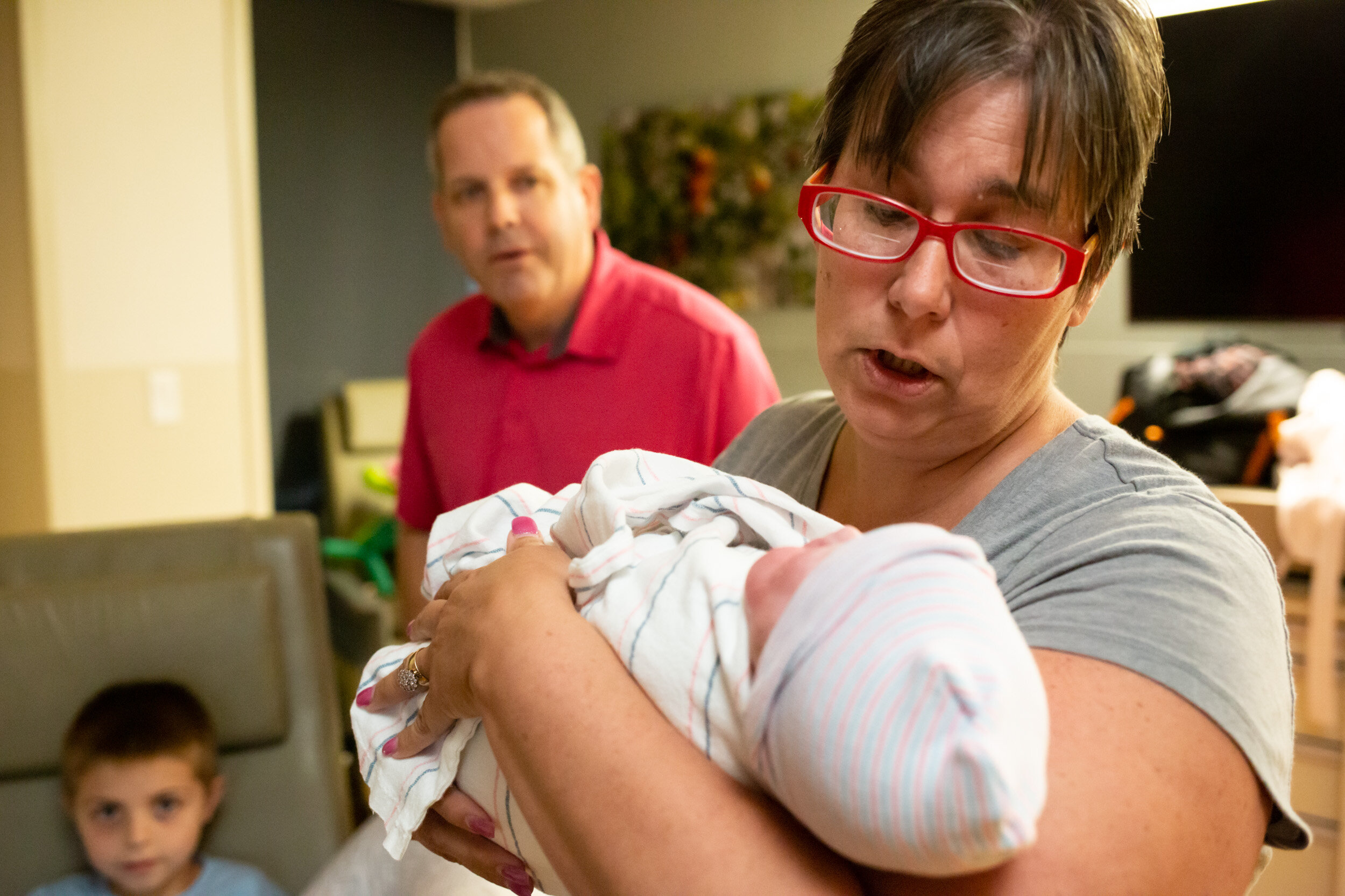 family friend holding newborn baby girl