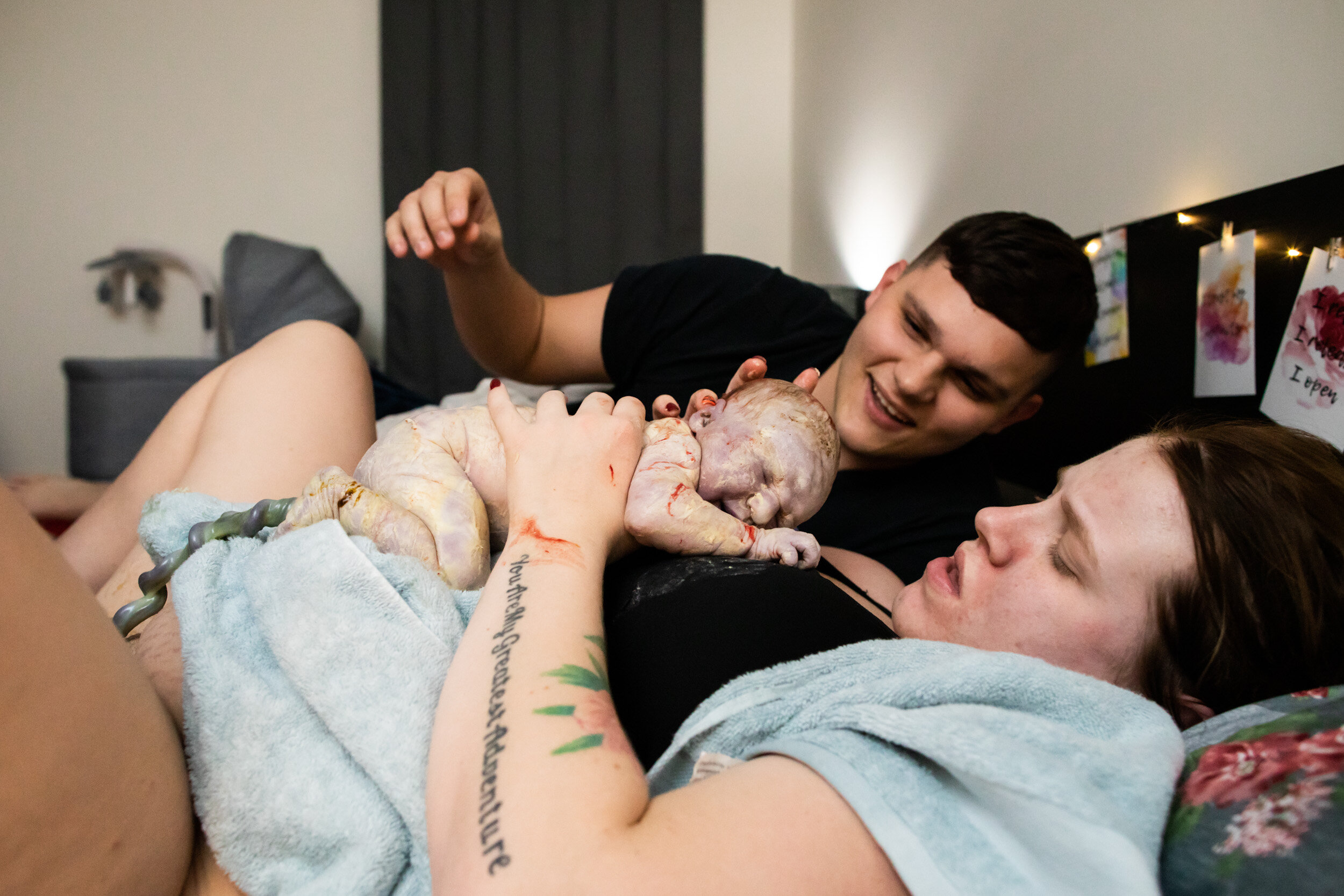 husband and wife adoring newborn baby girl
