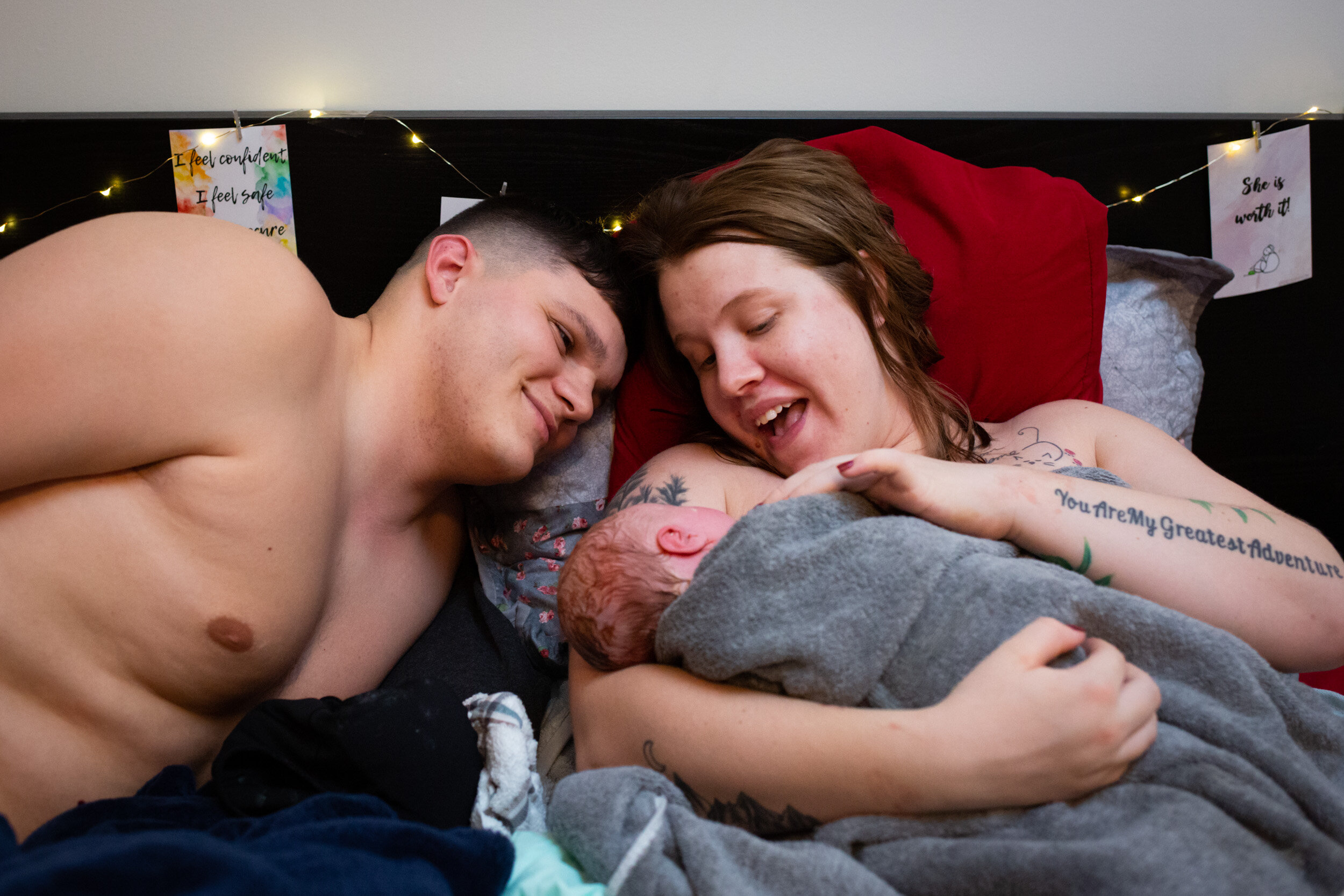 jacksonville parents smiling at their newborn baby girl at their home birth